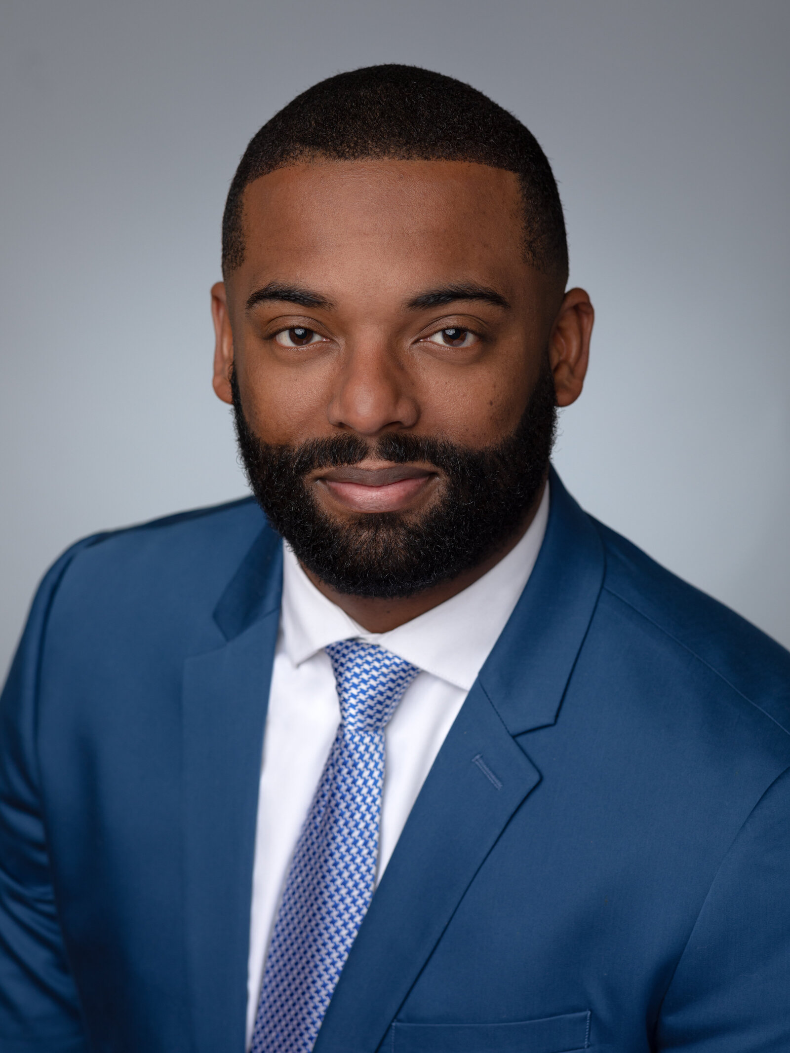 male headshot in blue suit