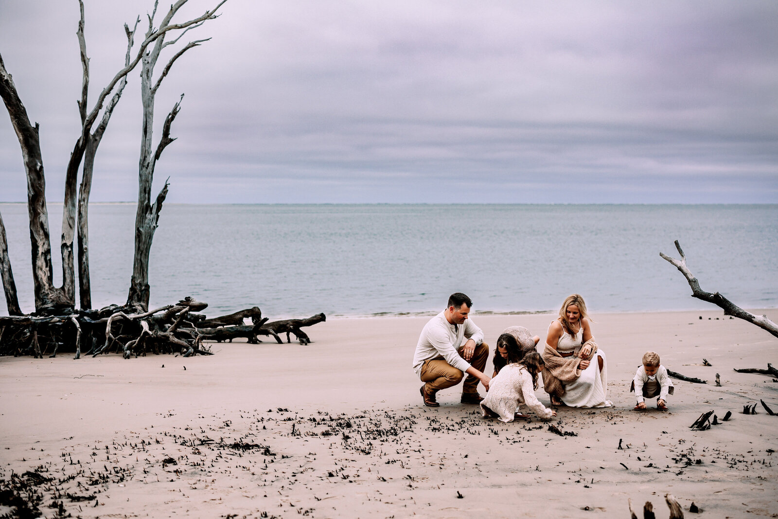 Family of five playing in the sand on Florida beach