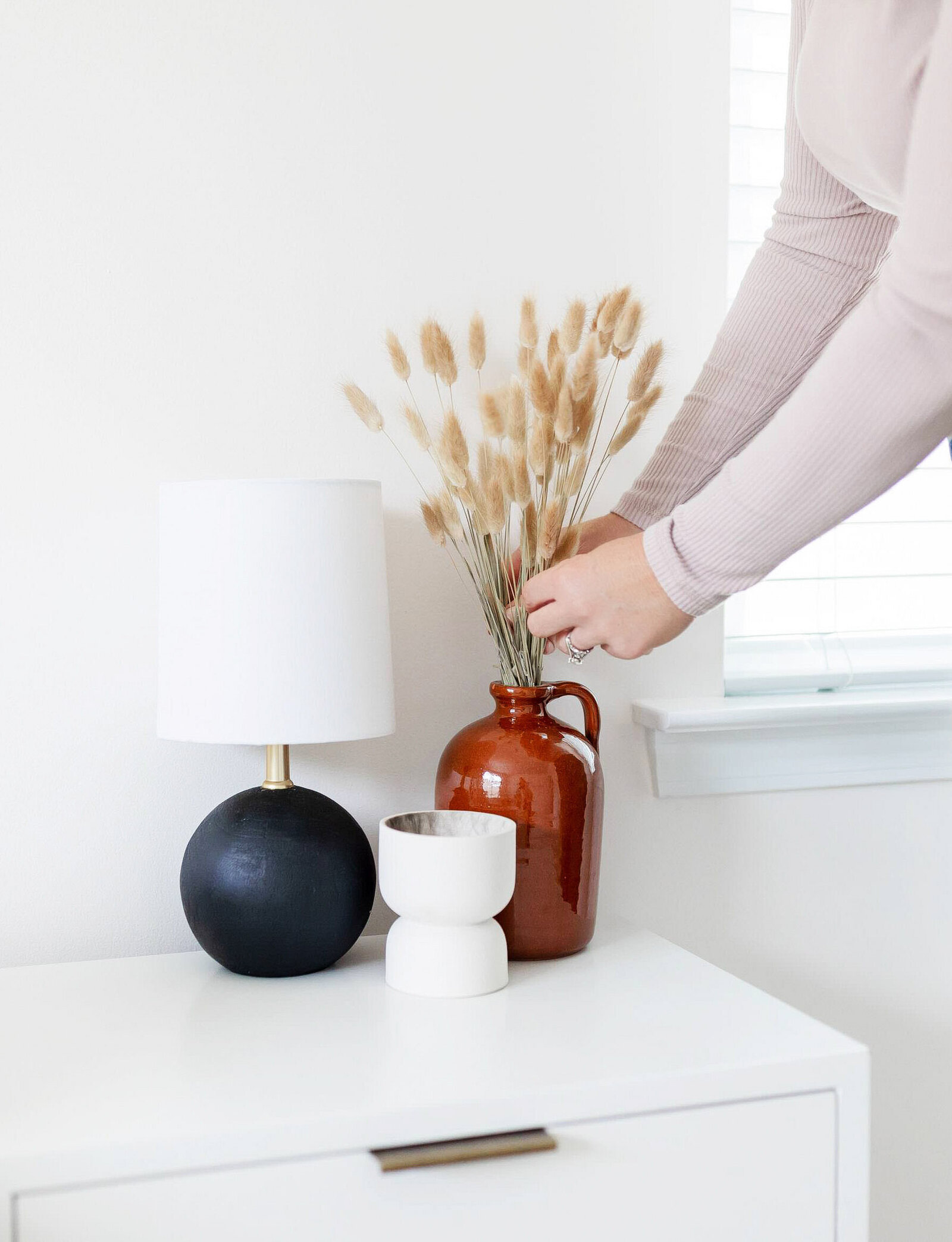 Woman placing flowers in vase