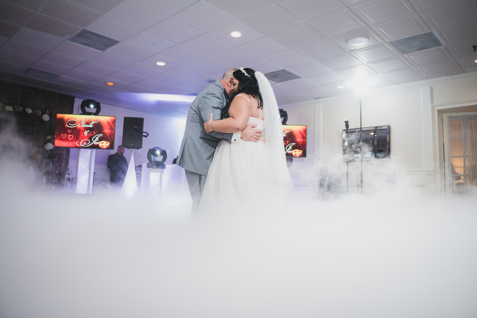 photo of bride and groom during first dance with fog from wedding at Sea Cliff Manor