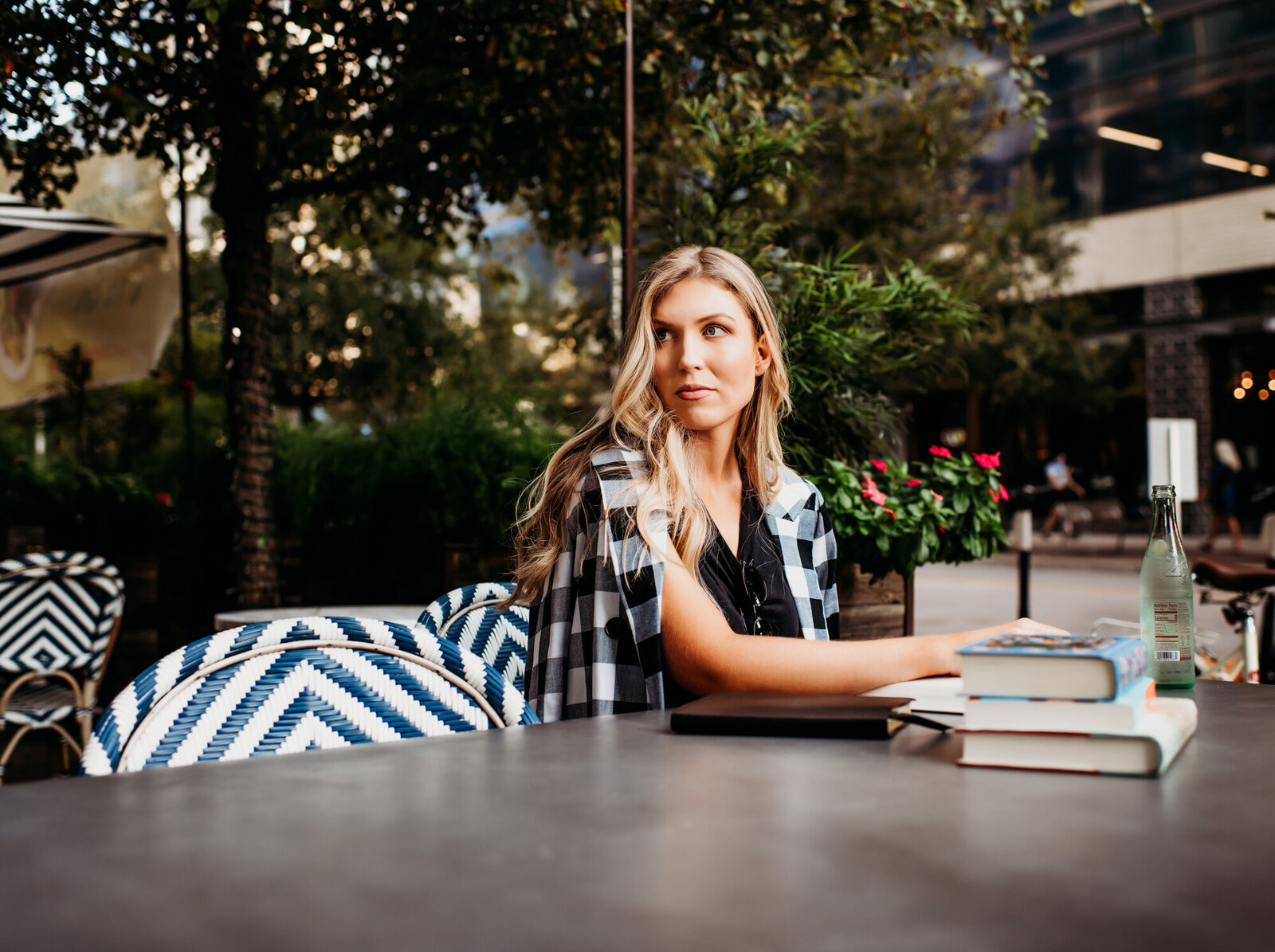 Branding Photographer, a woman sits at an outdoor table with her books