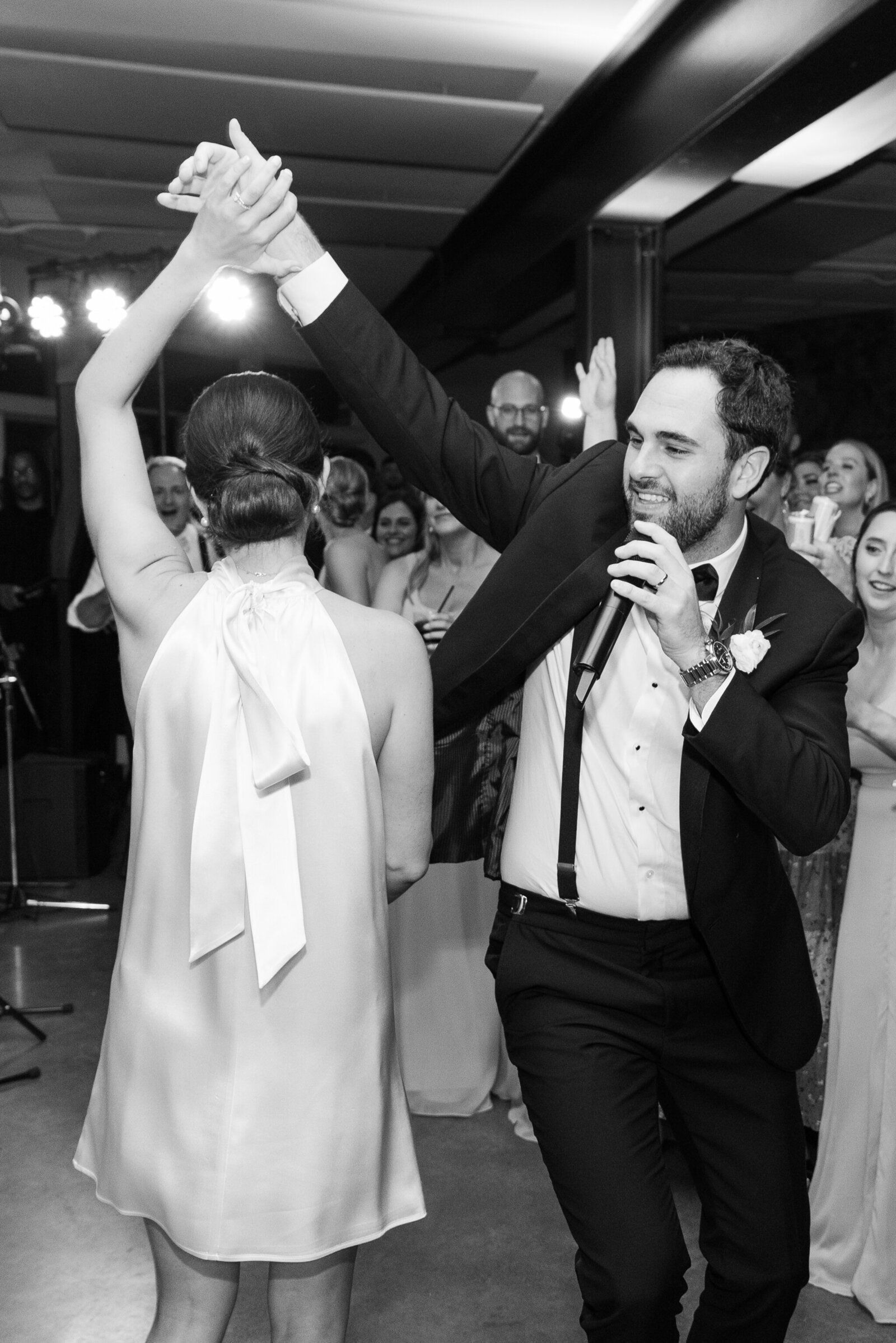 coupe singing and dancing during their wedding reception