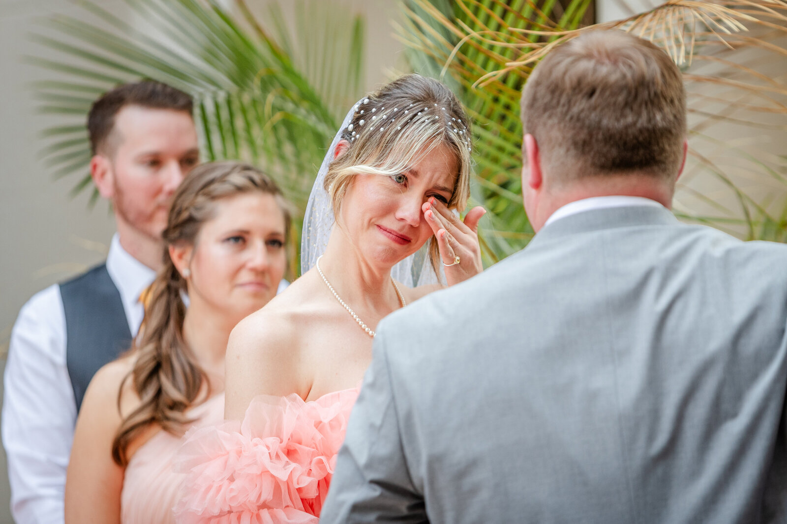 Bride wiping her tears during ceremony