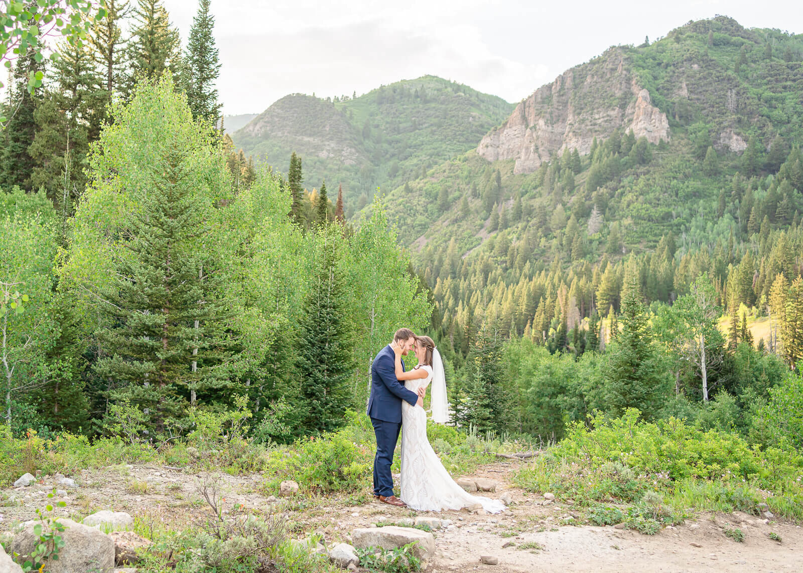 A bride and groom holding each other at Jordan Pines, Big Cottonwood Canyon.
