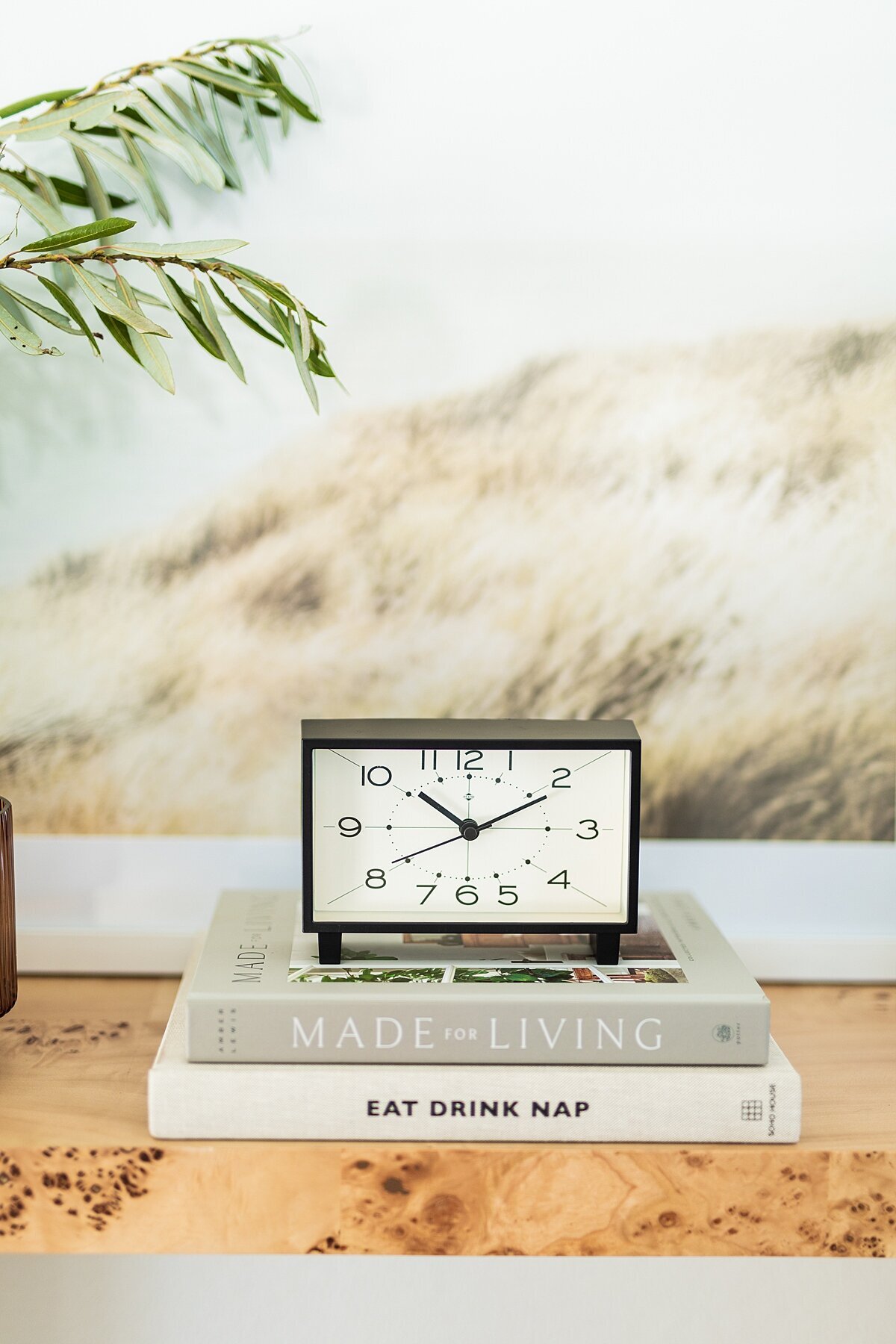 Clock and books on console table in San Marcos, California.