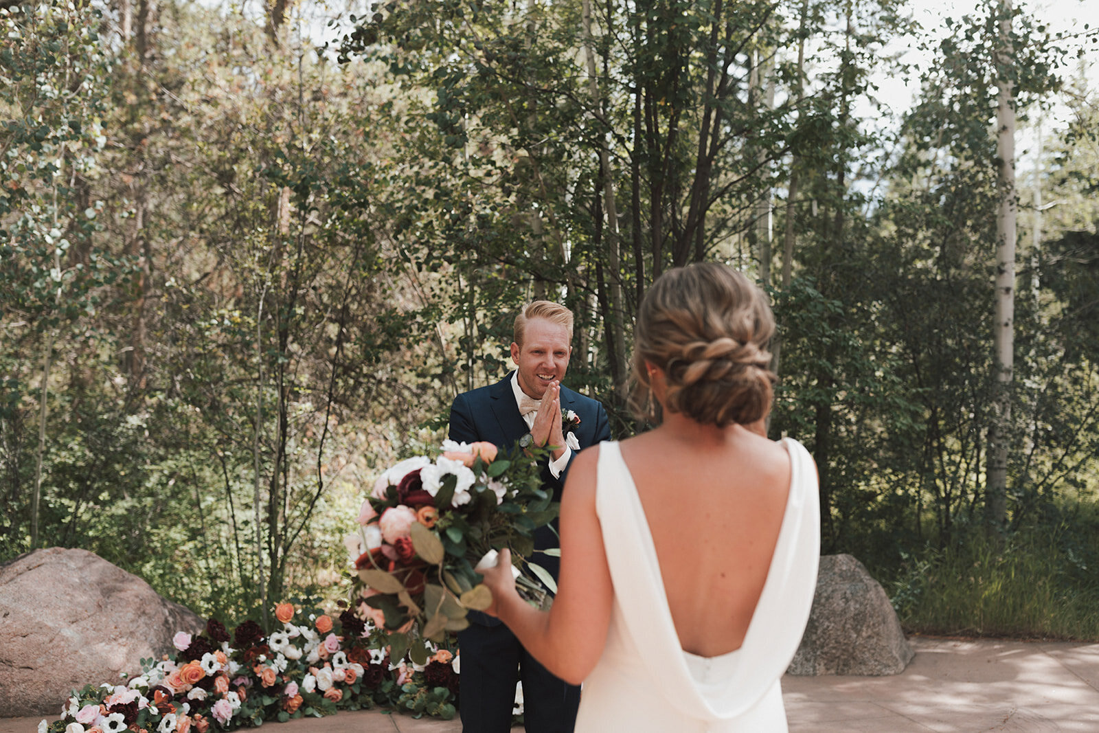 Bride holding her floral bouquet having her first look by his Father