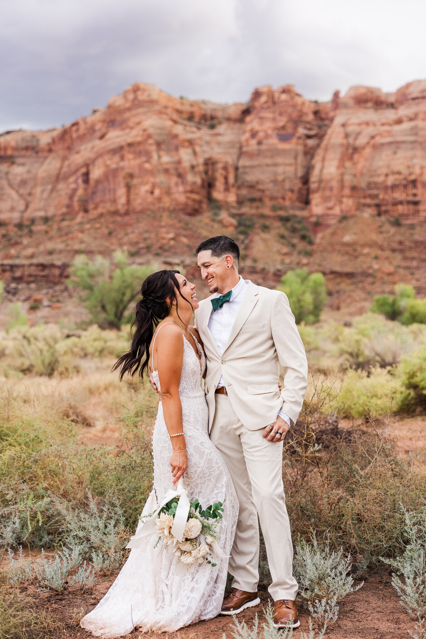 Groom holds bride during sunset during Utah Wedding