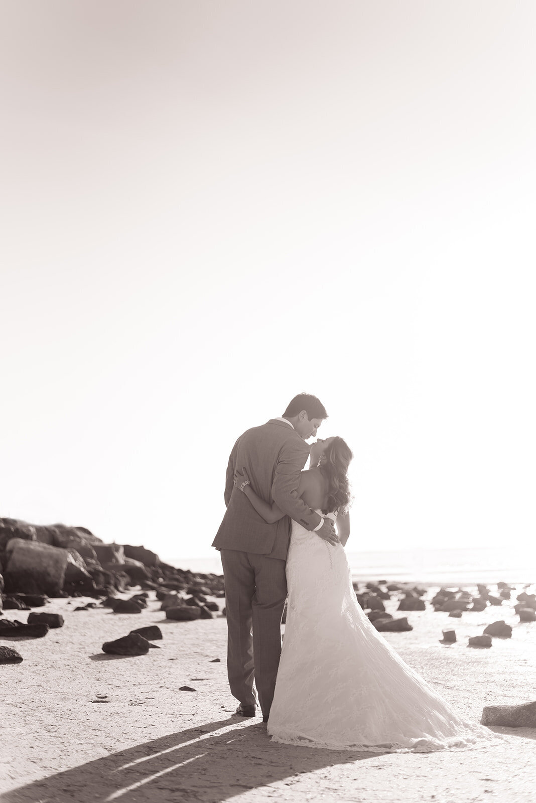 bride and groom kissing on beach in Florida