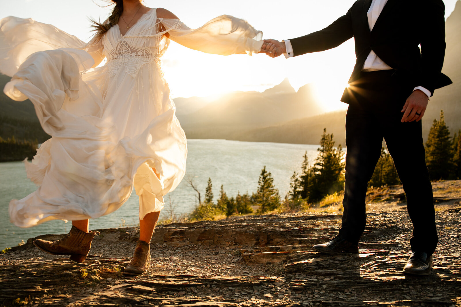 elopement near the water with sunset and beautiful mountains in background