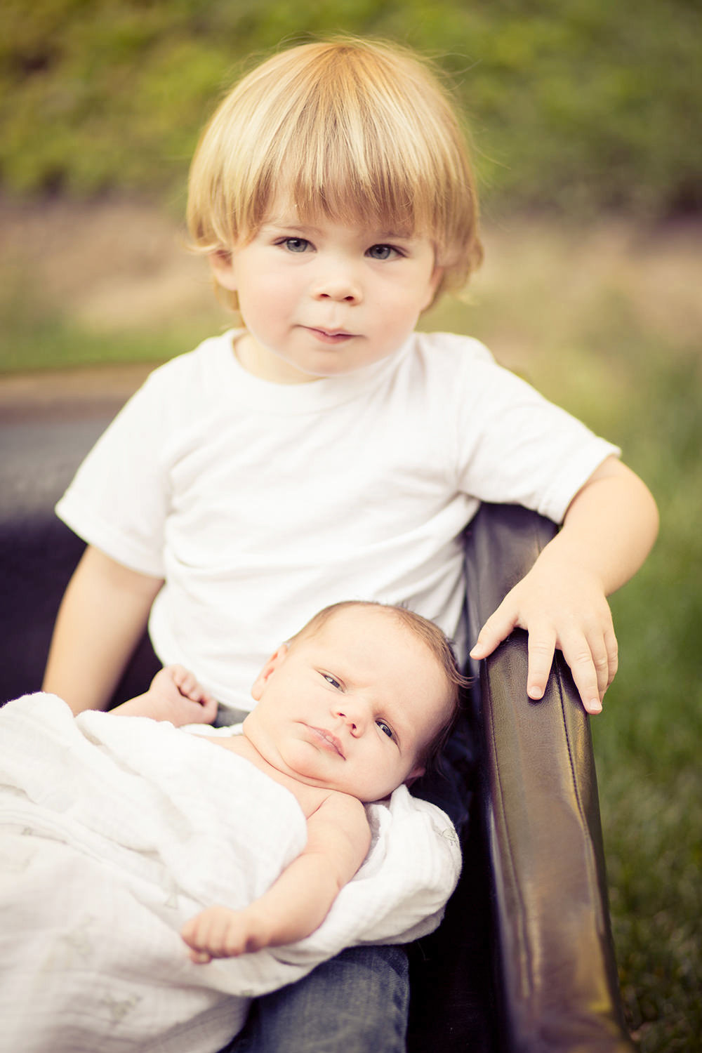 san diego family photographer | boy with newborn sister in a wicker basket