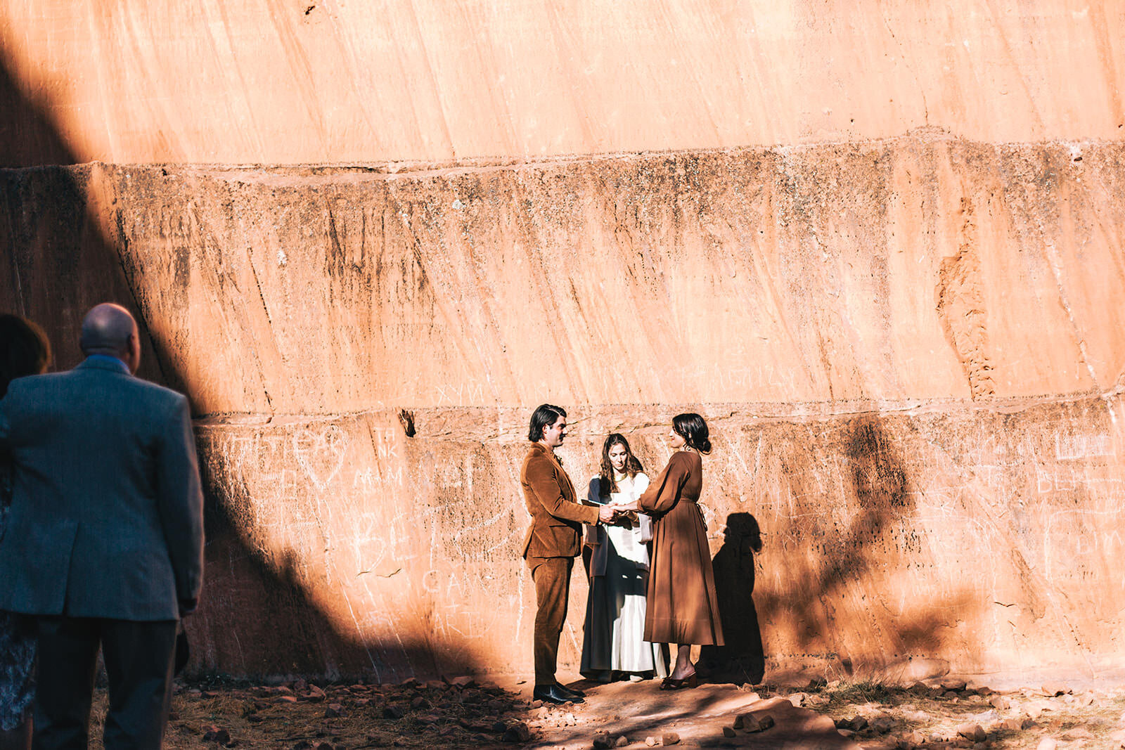 photo of couple sharing their vows with red rocks in the background