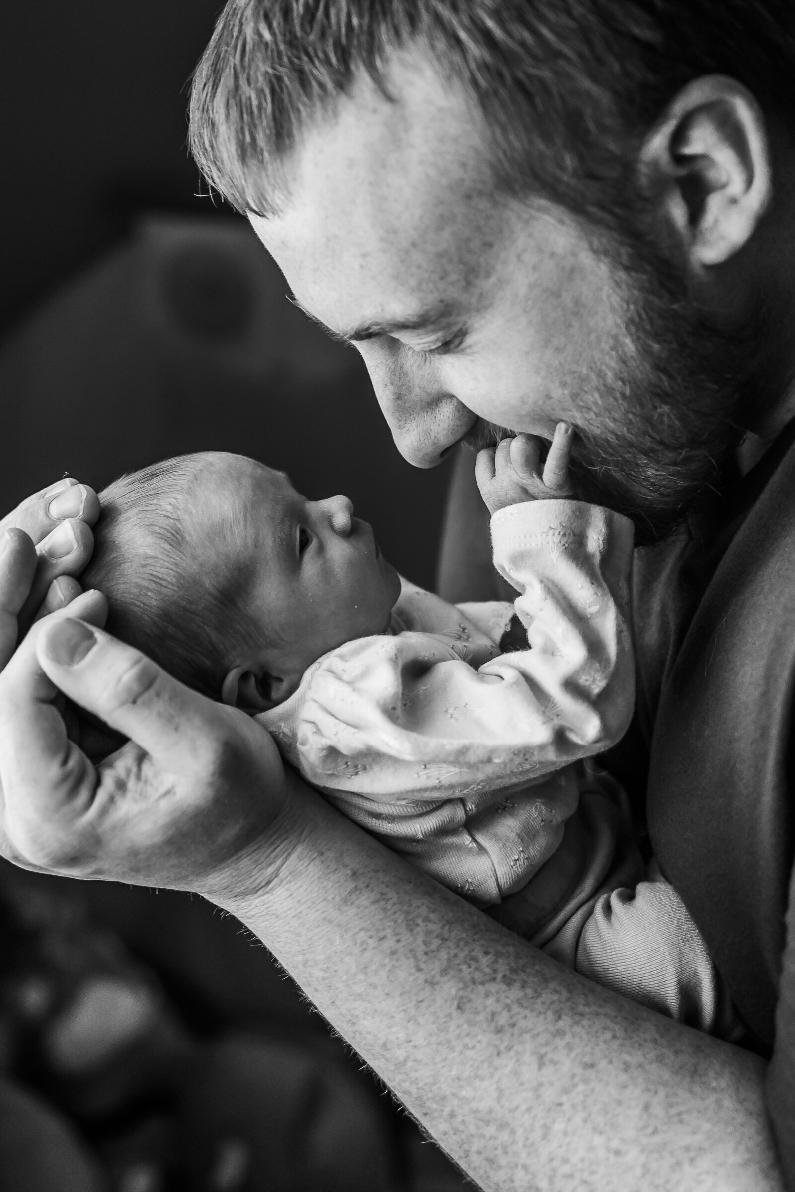 Newborn baby girl face to face with her dad