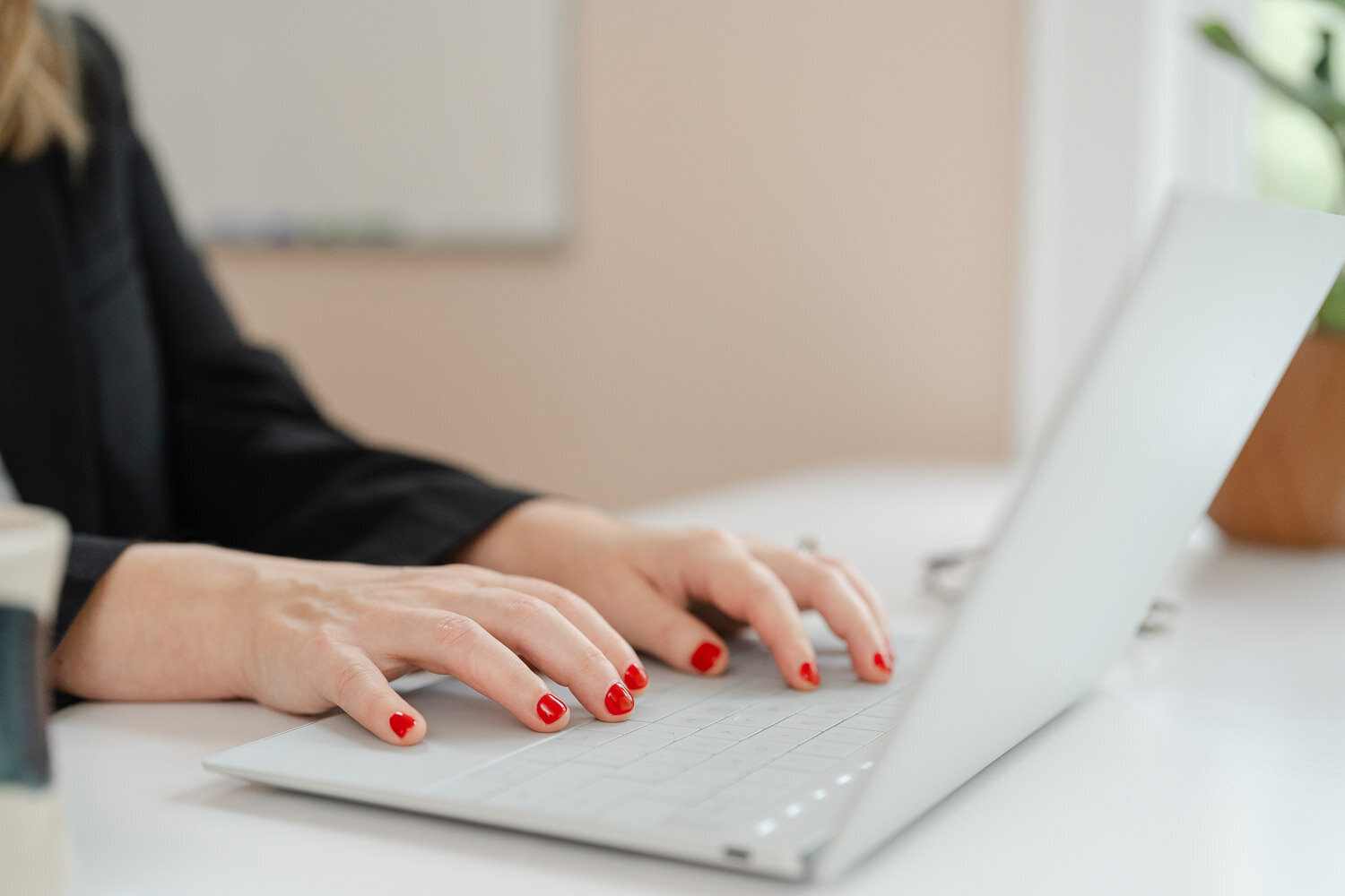 woman with red nails typing on a computer during Northern VA branding photo
