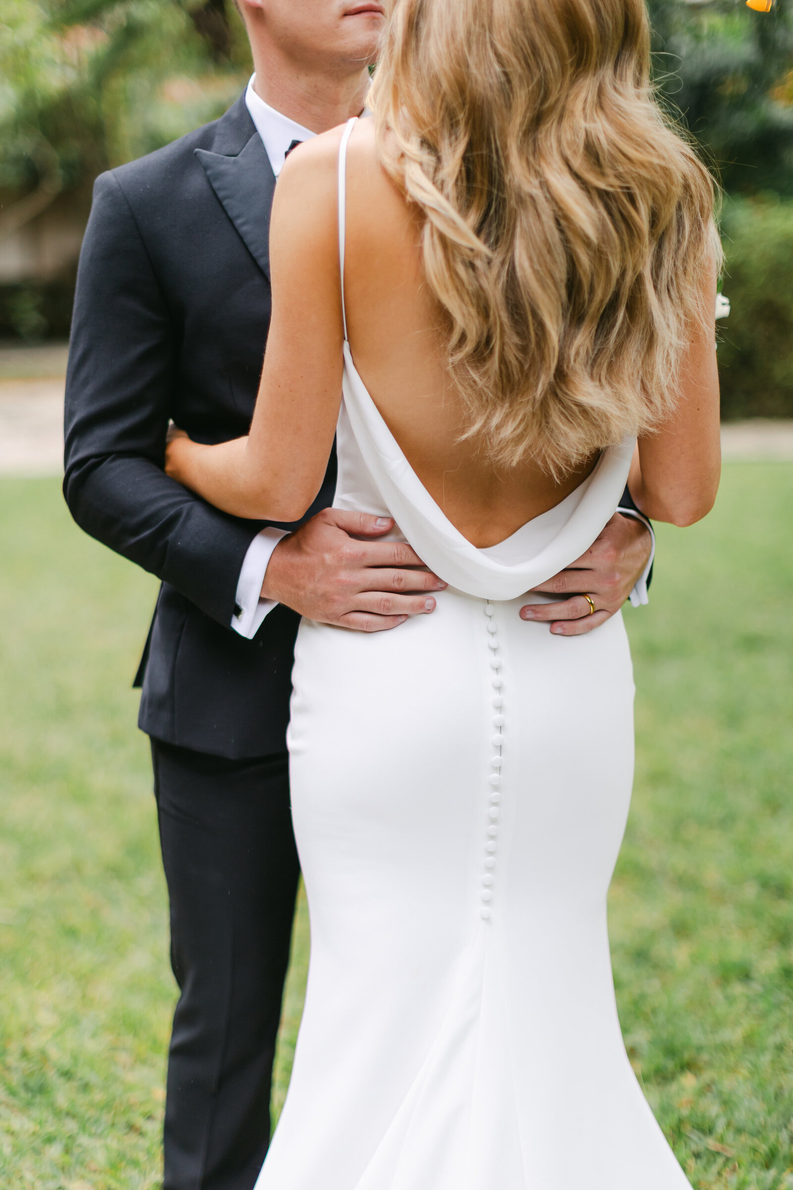 Elegant couple embrace during a Coral Gables Luxury wedding at Plymouth Congregational Church. Photo by Maggie Alvarez Photography