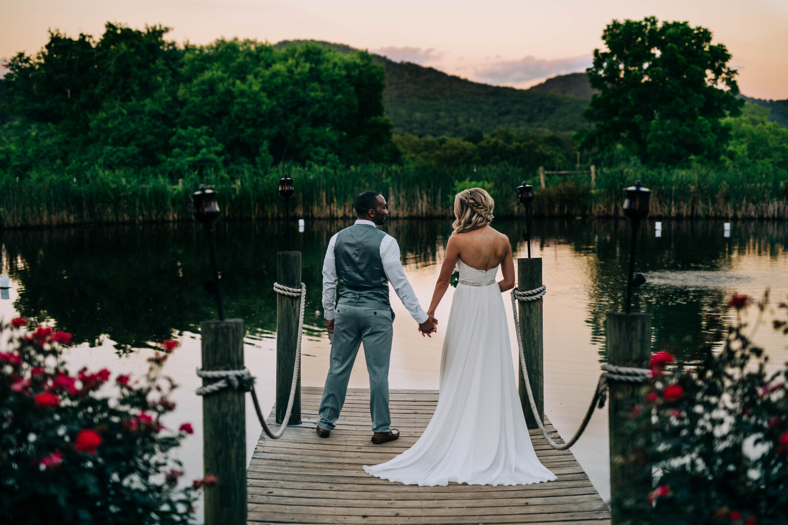 Lake wedding photo in Knoxville with bride and groom holding hands