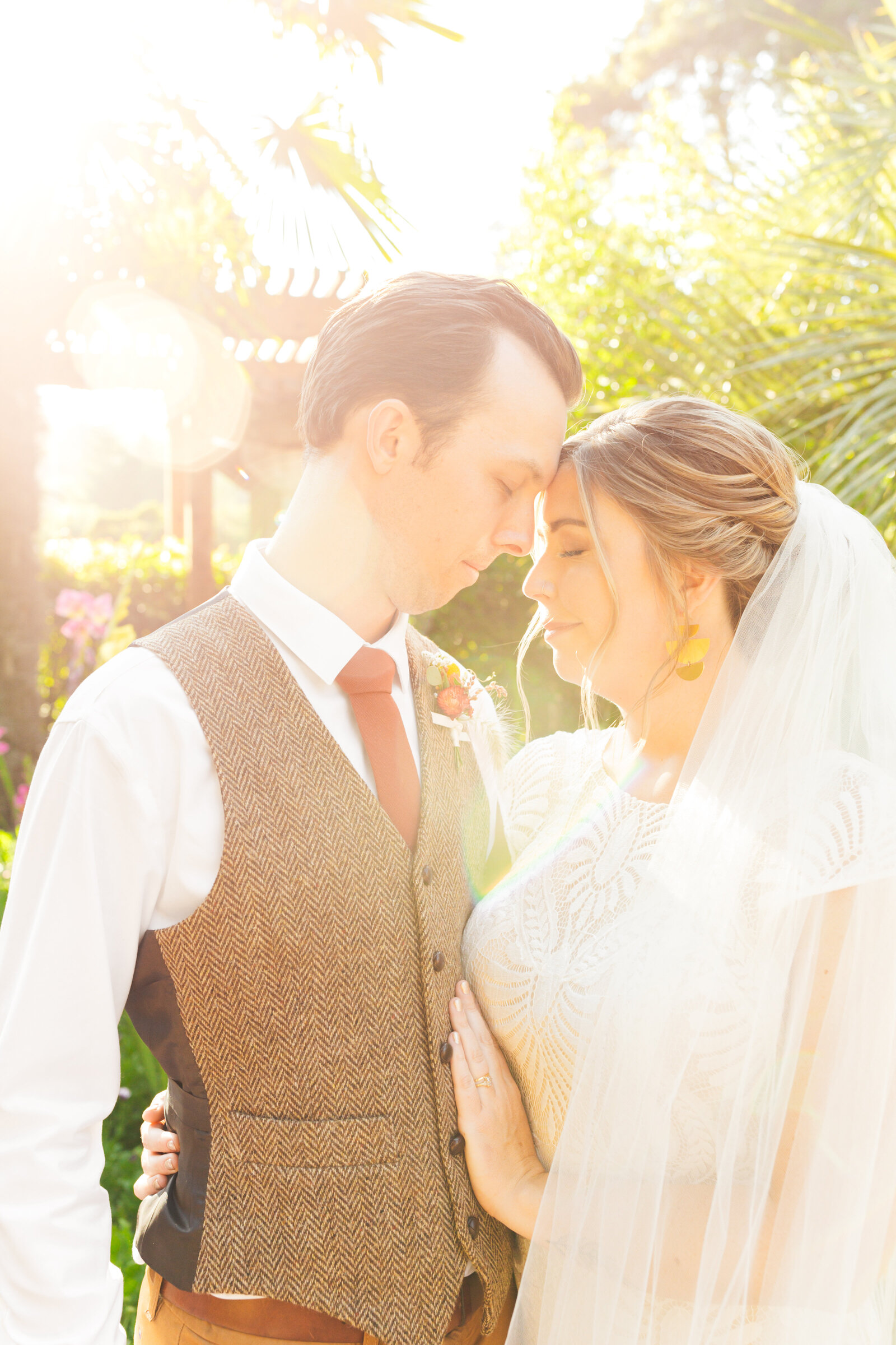 Bride and groom on their colorful wedding day in Santa Cruz, California in the redwood trees.
