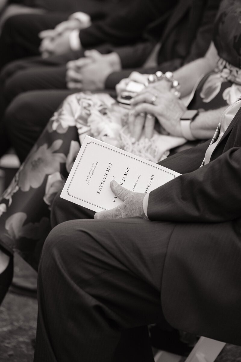 Guest holding wedding agenda by washington elopement photographer