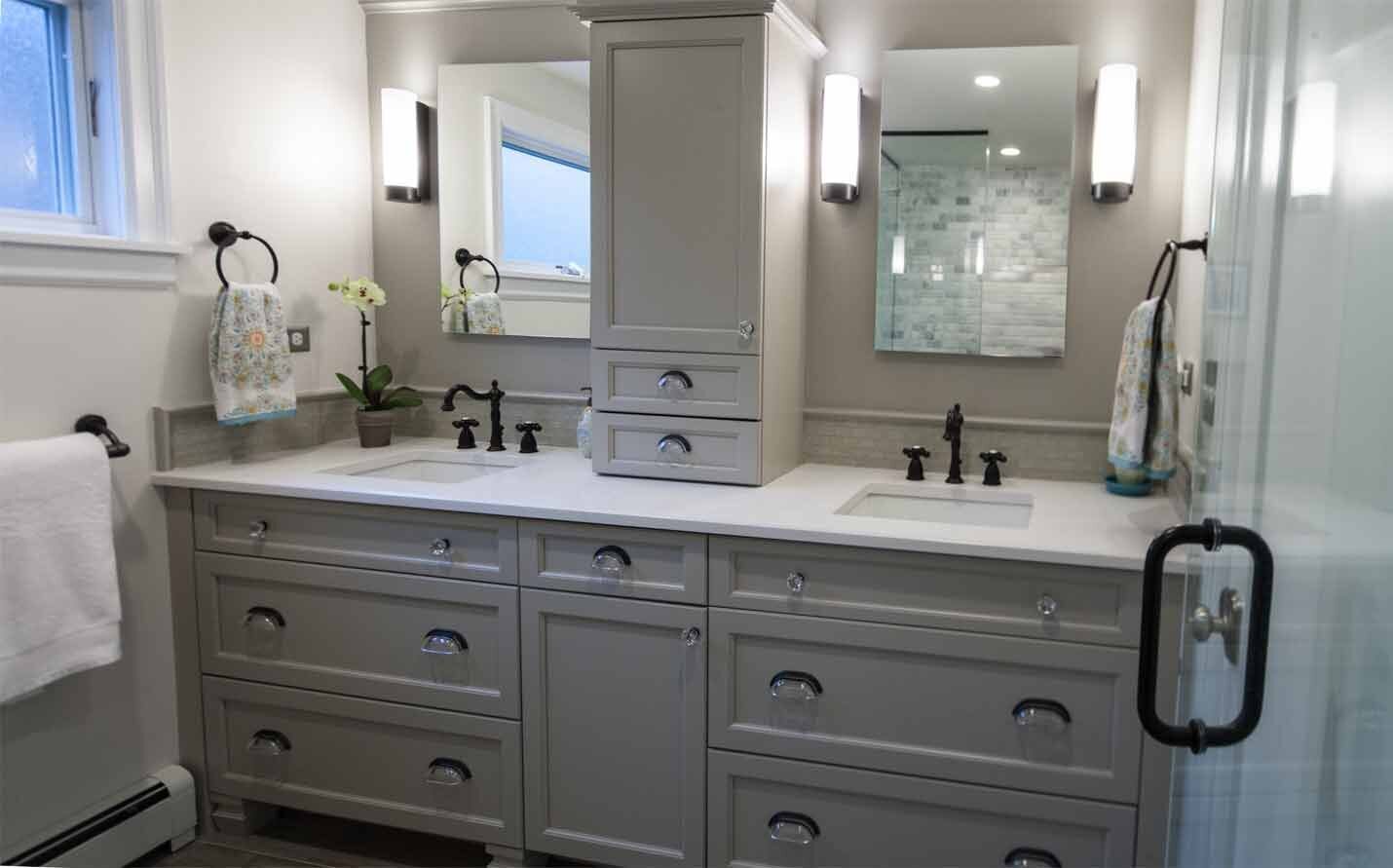 Bathroom with his and hers sinks with grey cabinets and a white counter