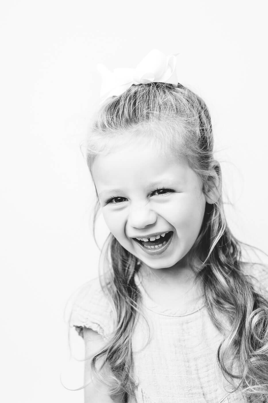 Monochrome of girl with hair up smiling ecstatically