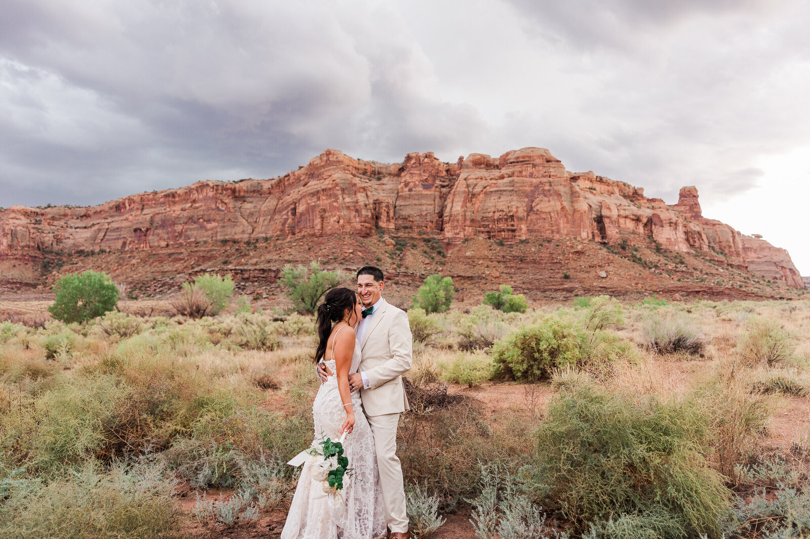 Bride and groom during their sunset portraits at the red earth venue in moab, utah 