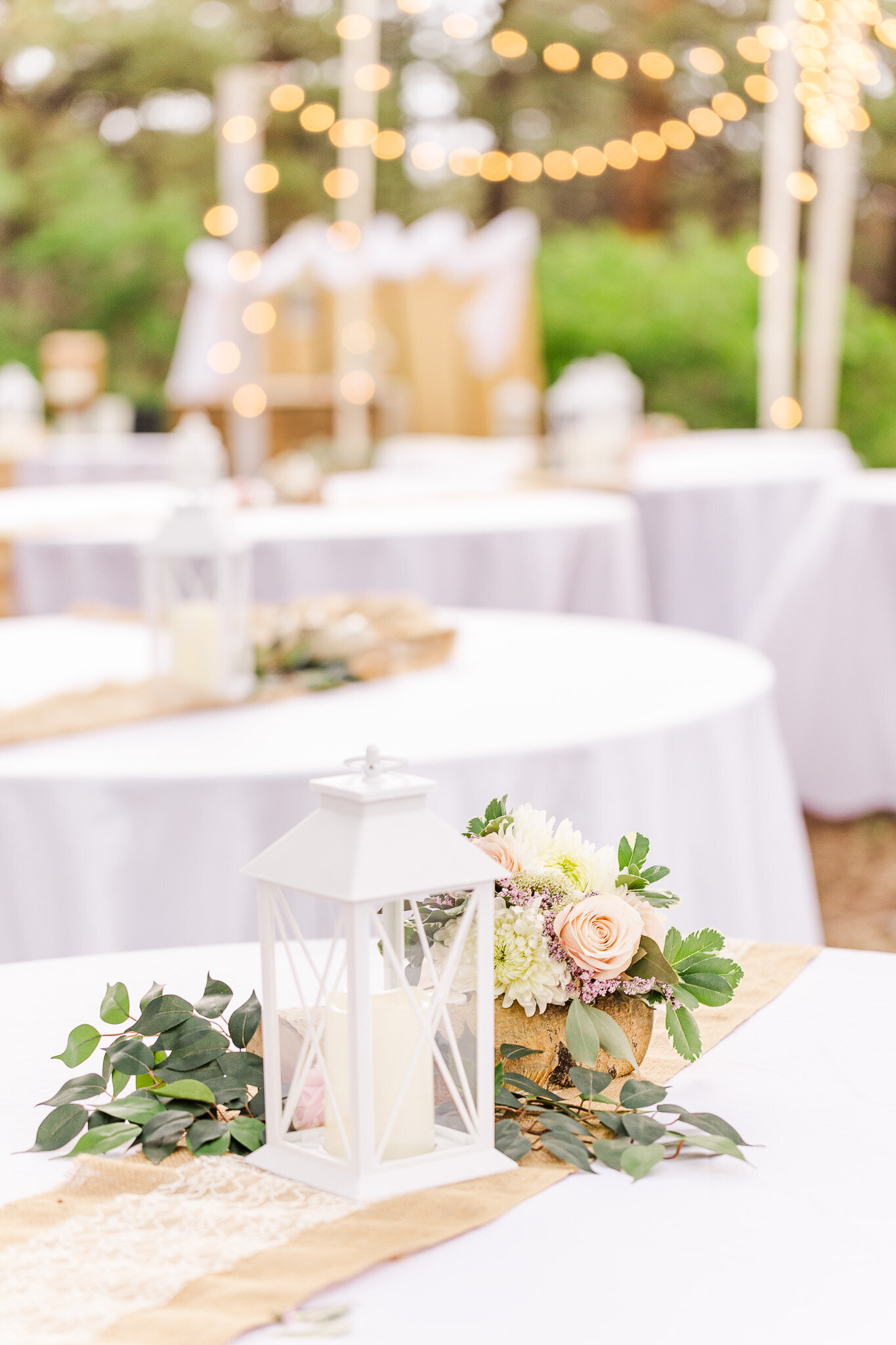 Lantern and florals on burlap on the wedding table