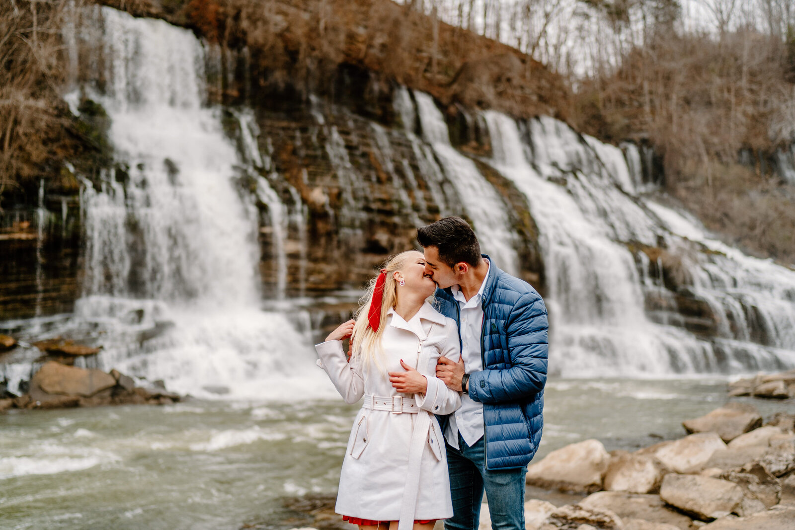 couple in front of waterfall in rock island, tennessee