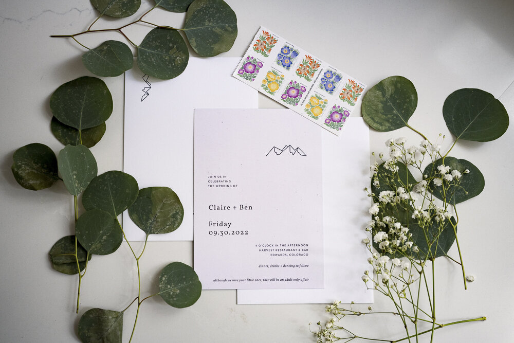 Wedding Invitation with stamps and eucalyptus leaves