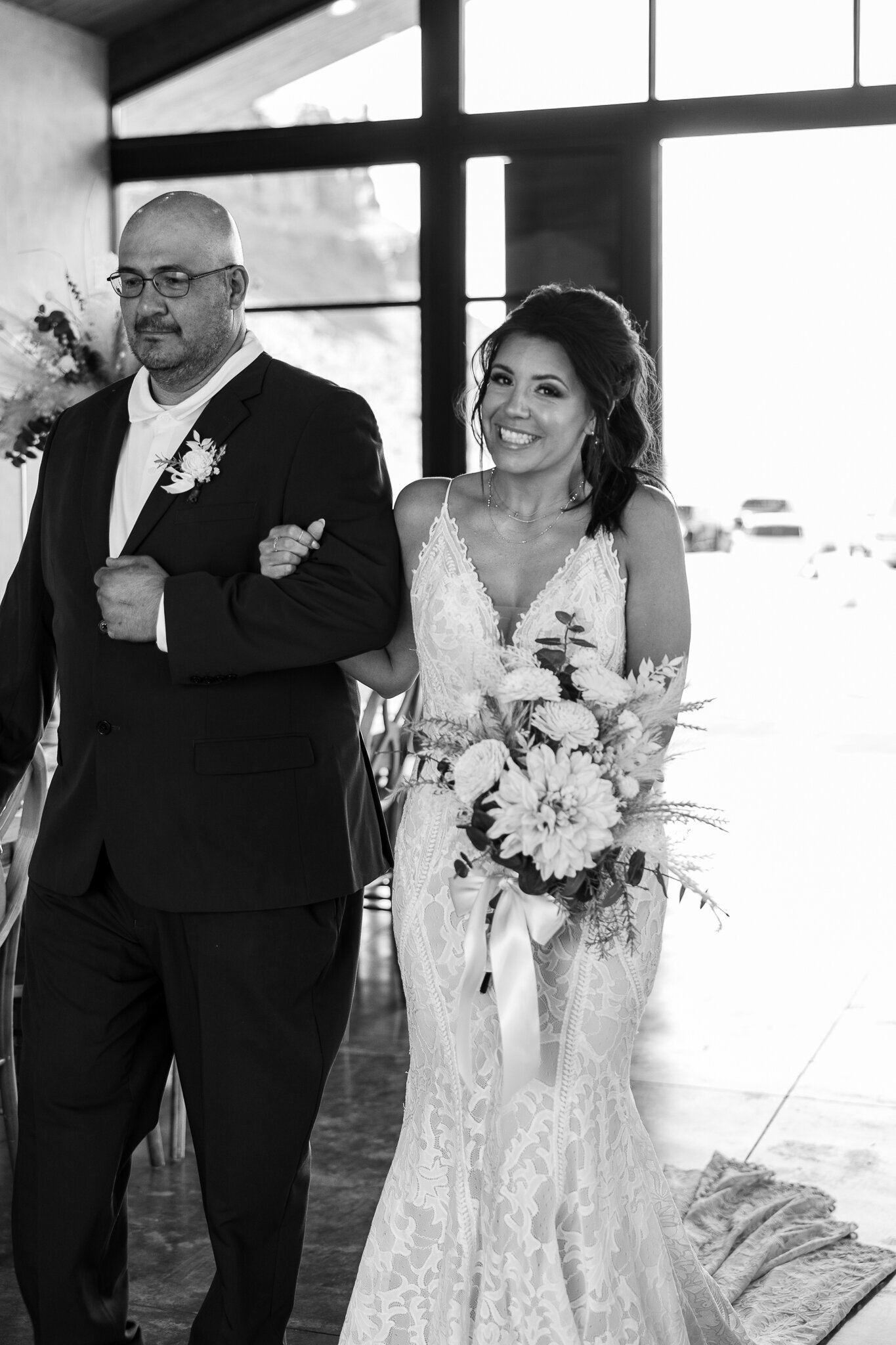 Bride being walked down the aisle by  her father on her wedding in Utah