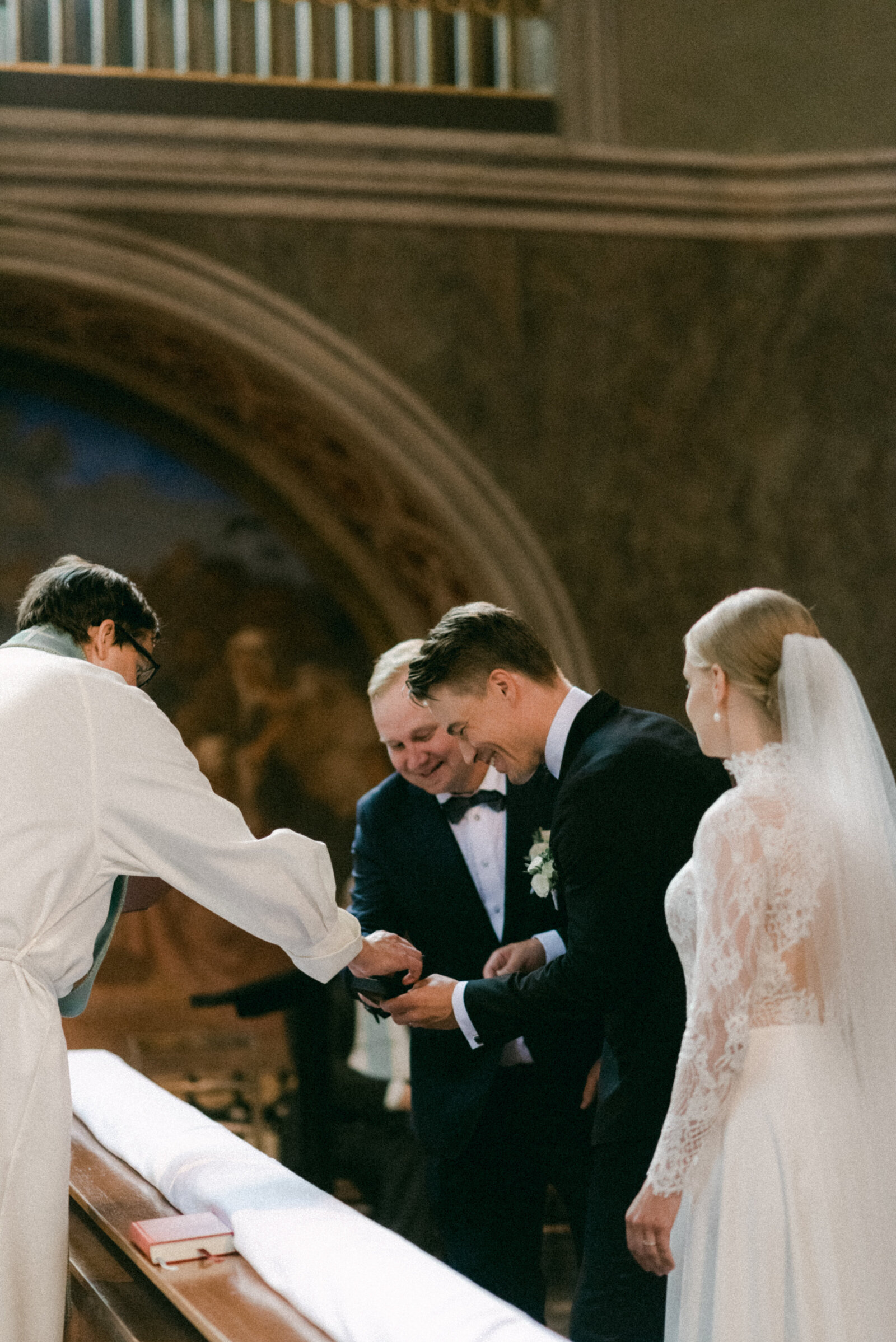 Bestman handing over the wedding ring during the ceremony in Turku cathedra.. Documentary image by wedding photographer Hannika Gabrielsson.