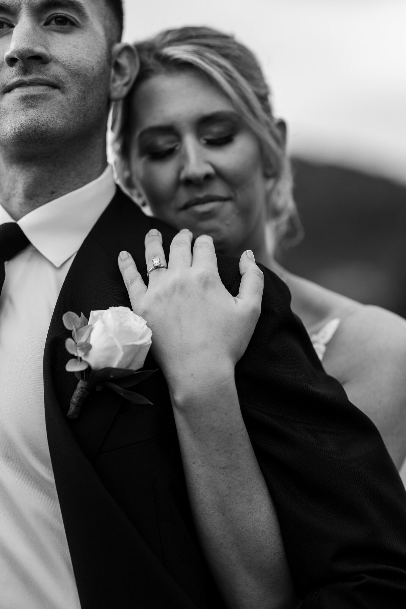 Intimate close-up of bride holding groom during emotional first look at SkyView Golf Club