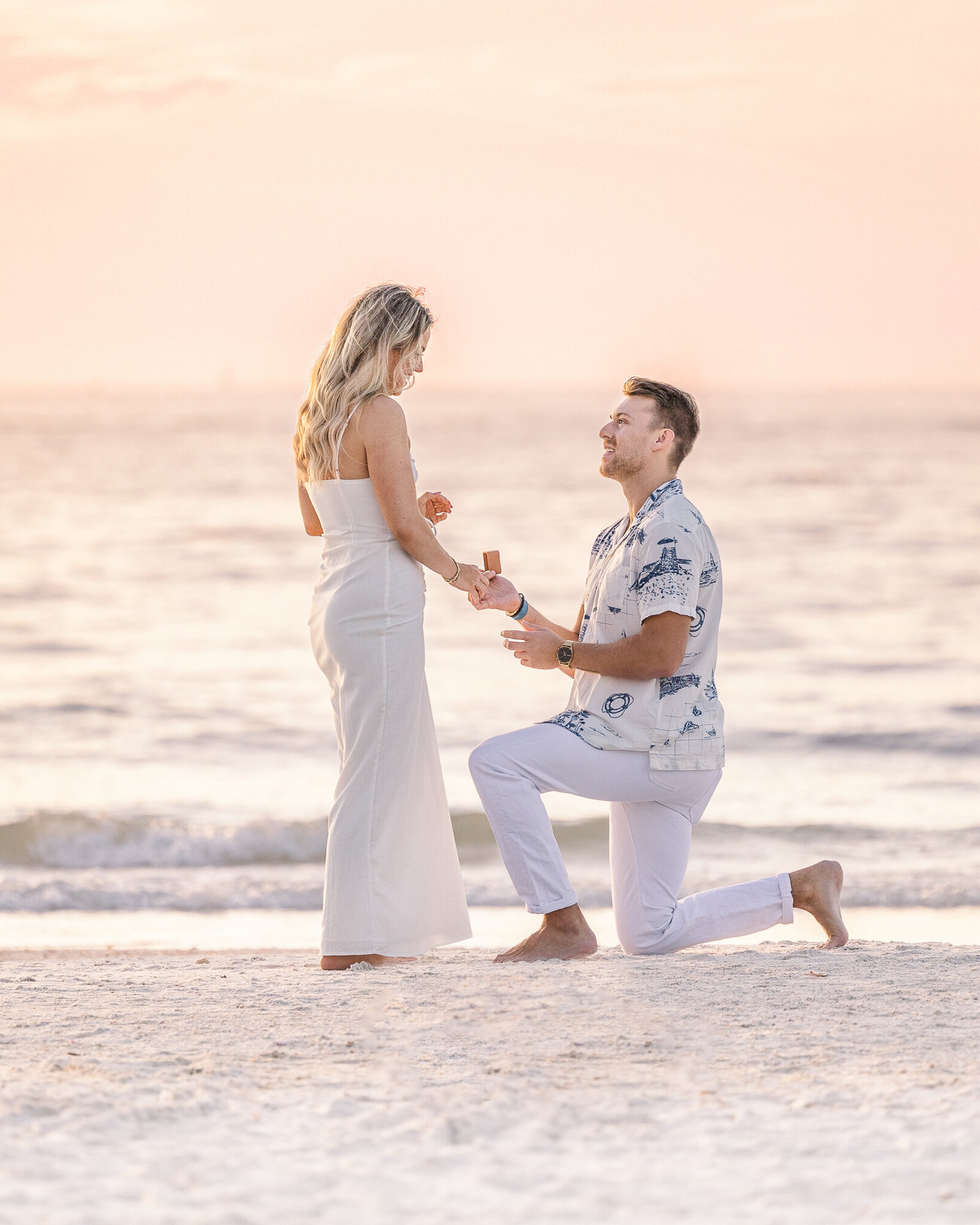 A man proposing to a woman on Clearwater Beach, Florida
