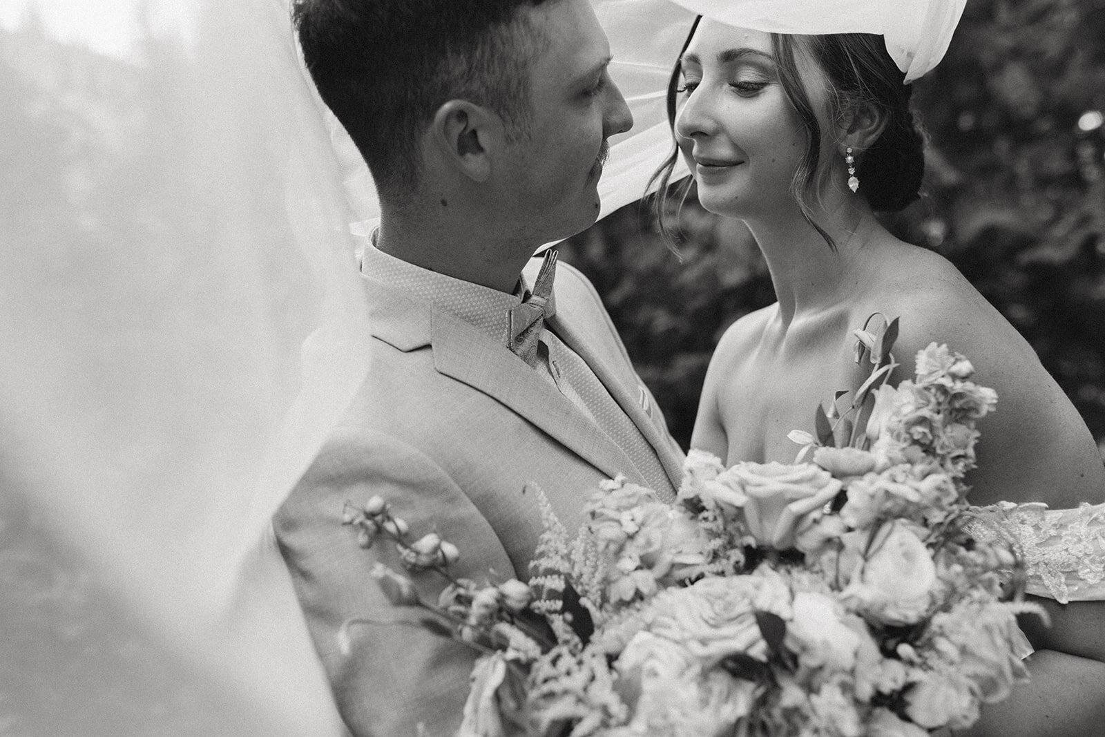 intimate photo of bride and groom under veil during their cranbrook wedding