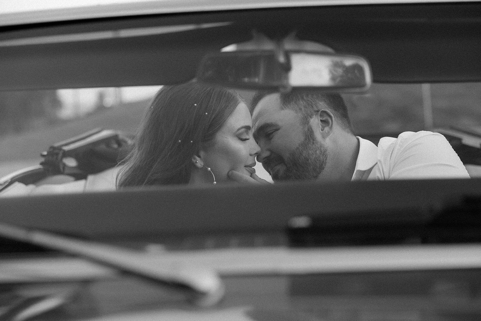 Couple share a romantic kiss in their car parked at the Parthenon in Nashville, TN.