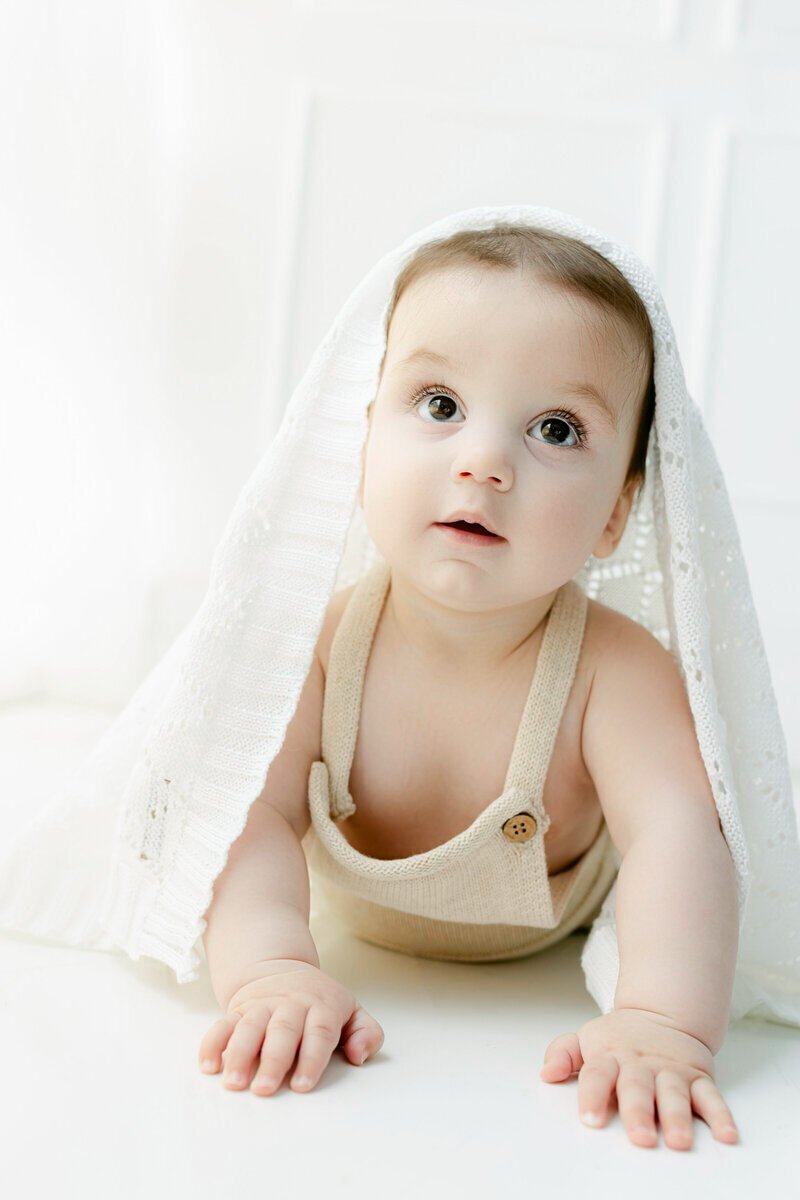 Baby with blanket on head by nj cake smash photographer