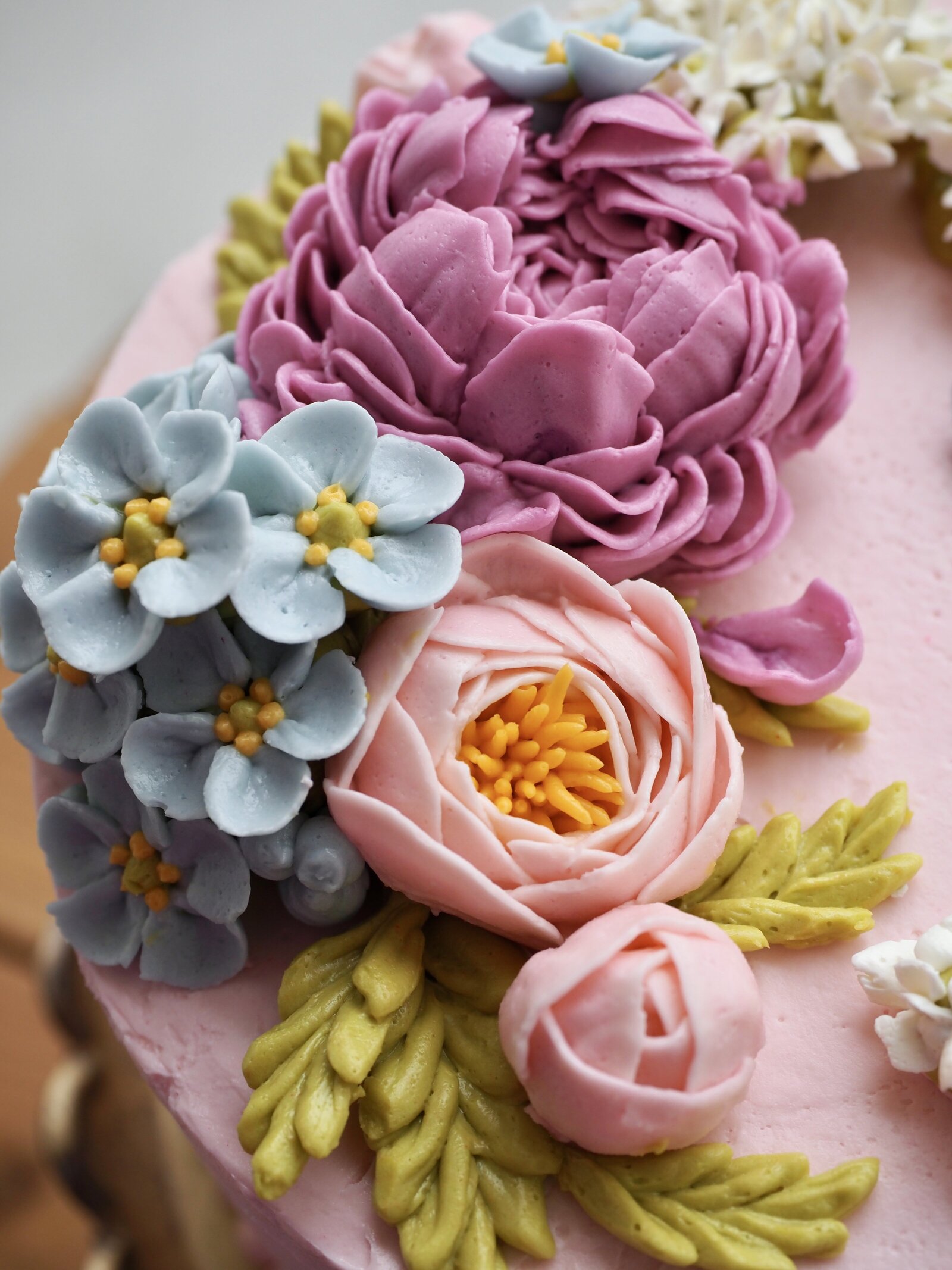 Close up of flowers on a buttercream flower cake
