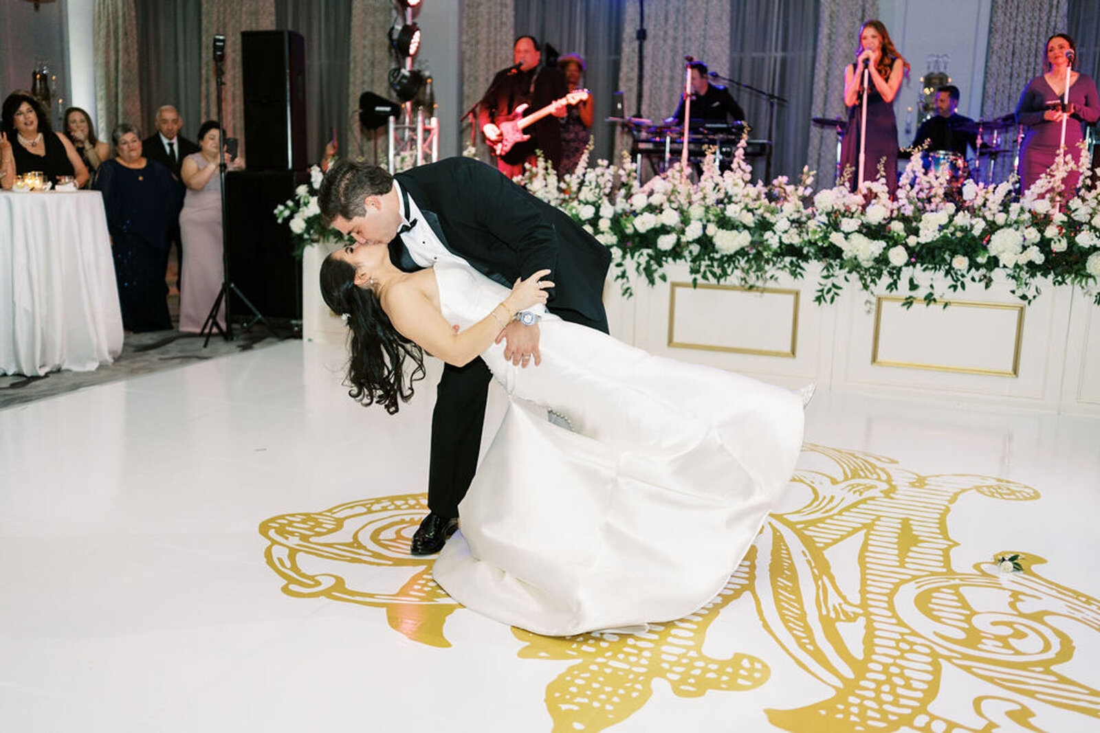 bride and groom dancing on monogrammed dance floor