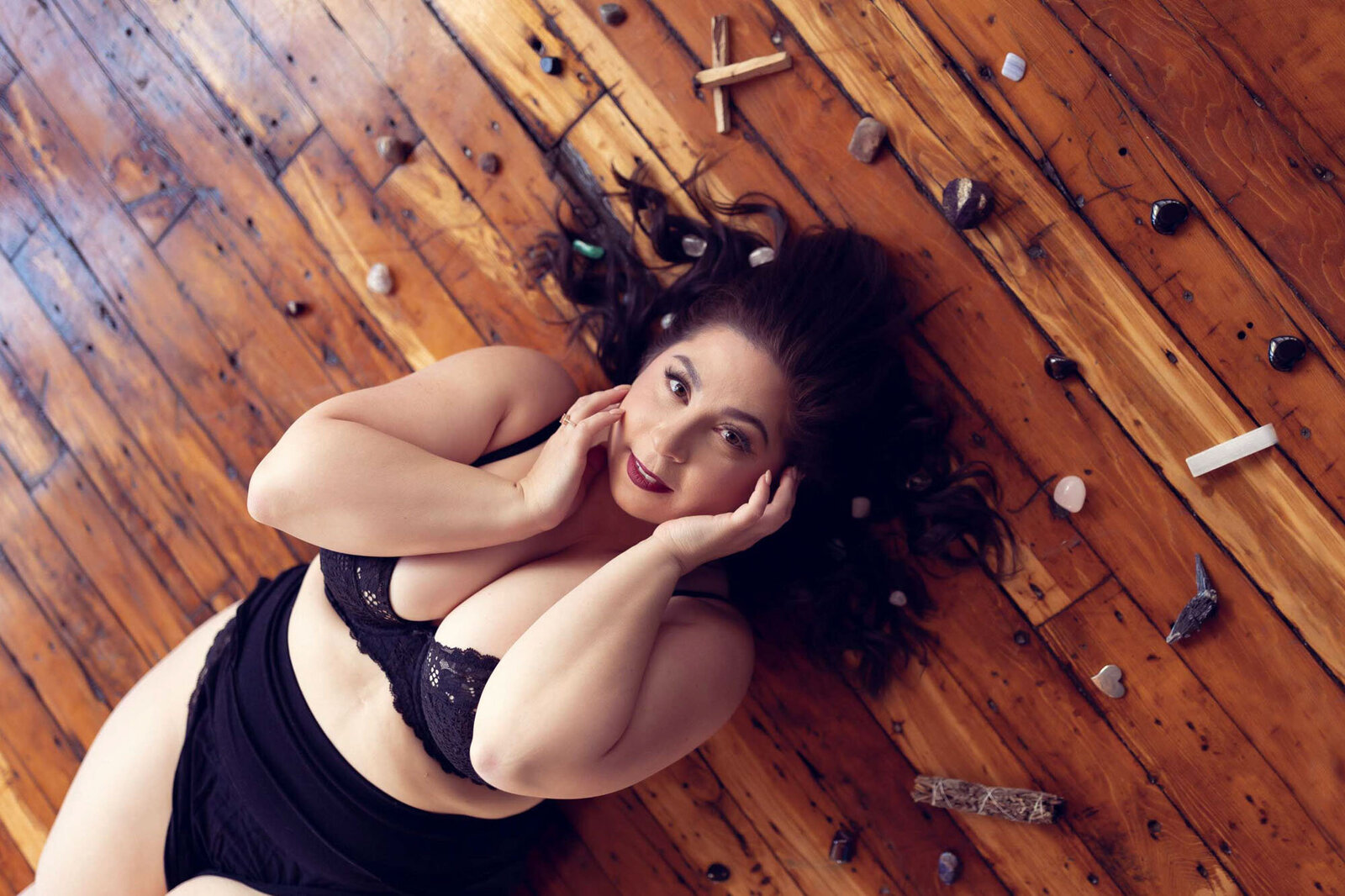 woman in a black lingerie laying on the floor