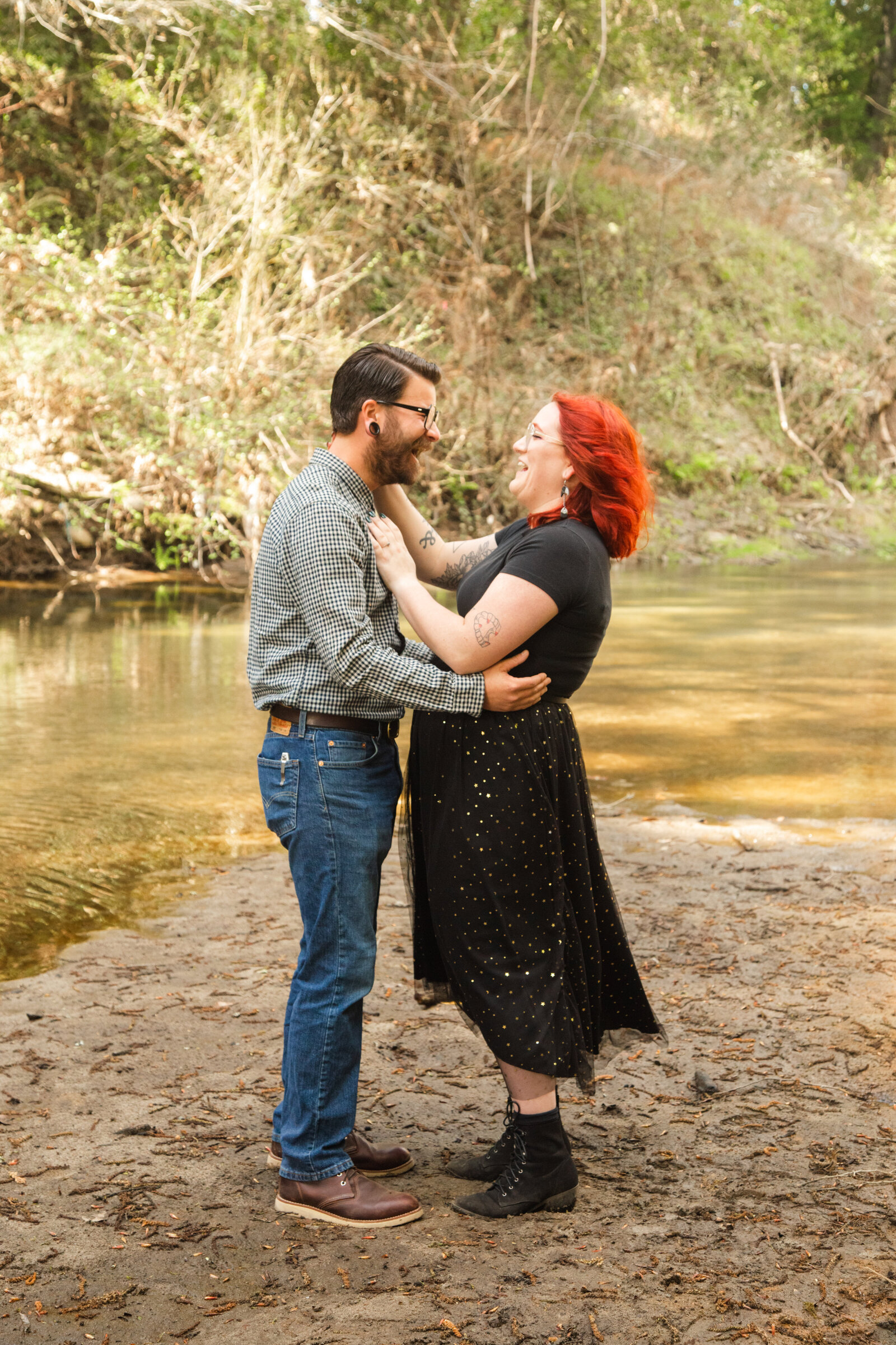 An tattooed engaged couple poses for photos in a redwood forest in Santa Cruz, Ca.