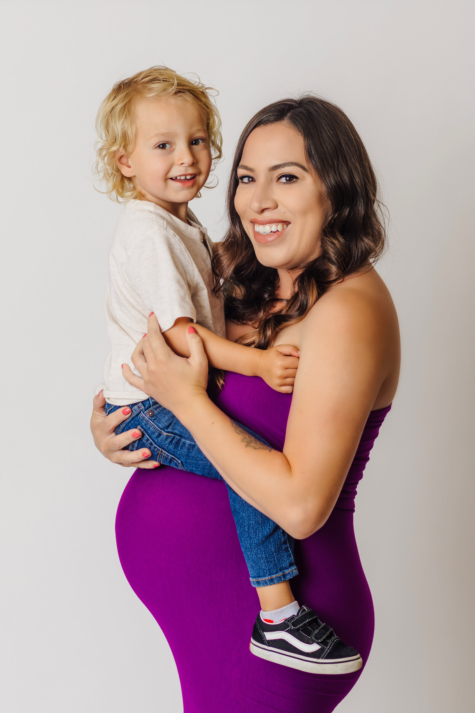 Maternity Photographer, a mother-to-be holds her young child