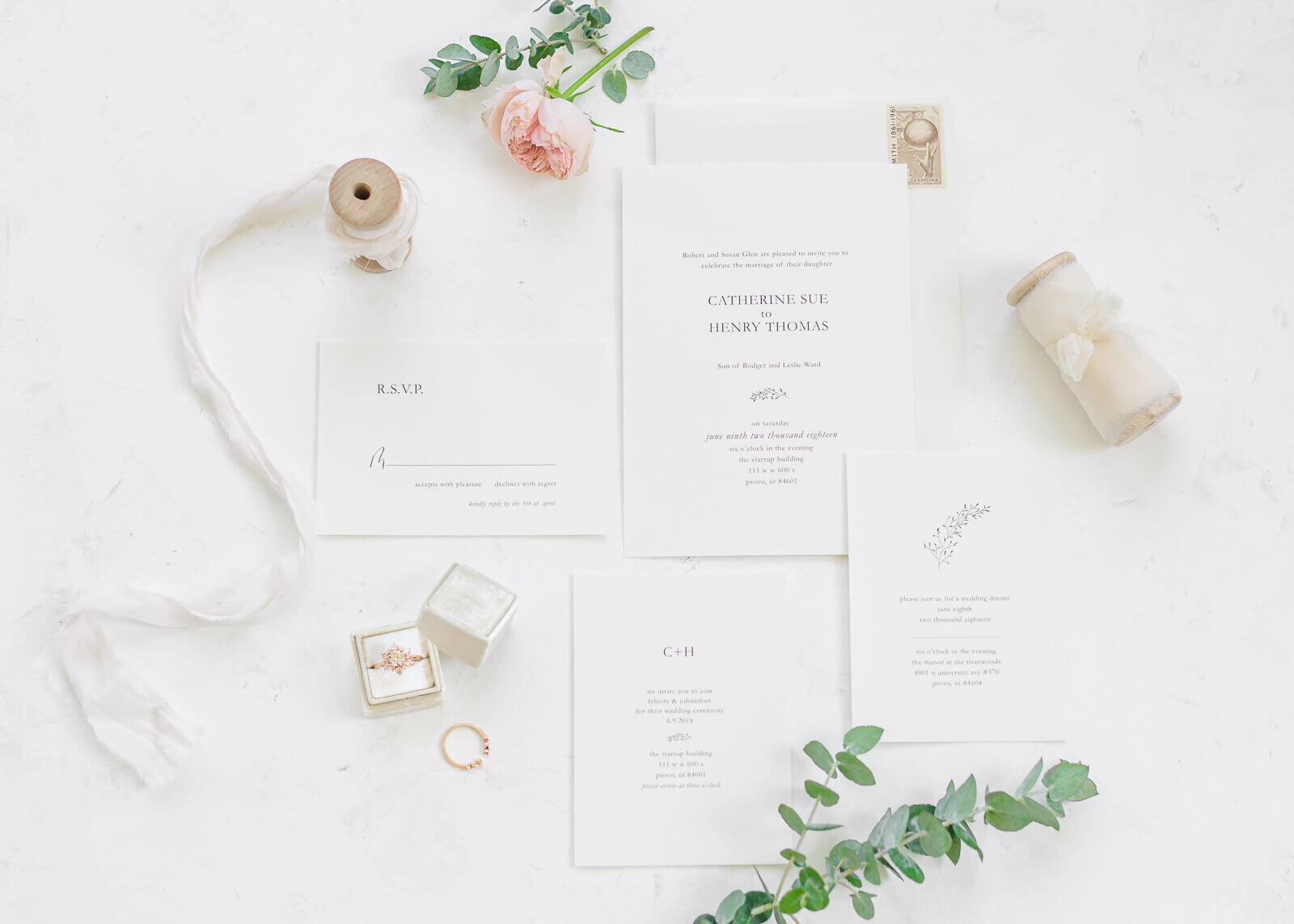 A wedding invitation suite accented with white ribbons and eucalyptus. Captured by Salt Lake City Wedding photographer Melissa Woodruff Photography