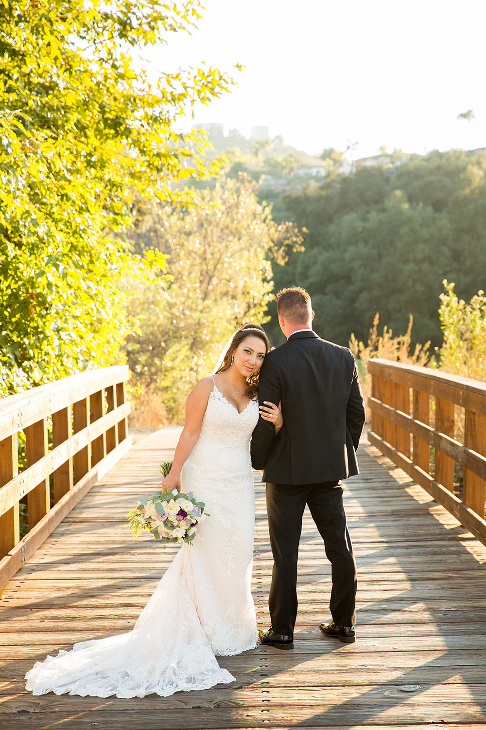 bride and groom on bridge