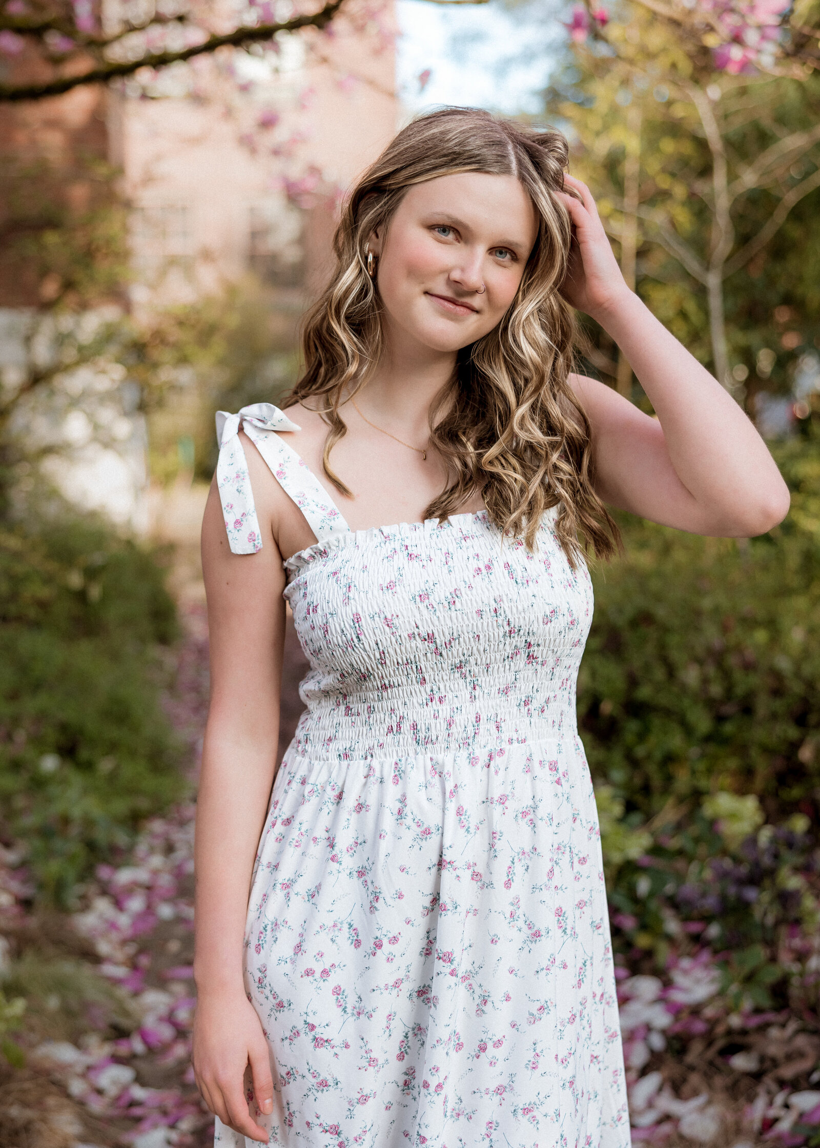 Girl posing in white dress in a garden