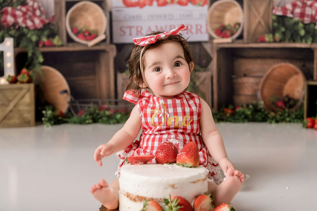 Portrait Photographers CT capture sweet strawberry-themed first birthday celebration with red gingham outfit
