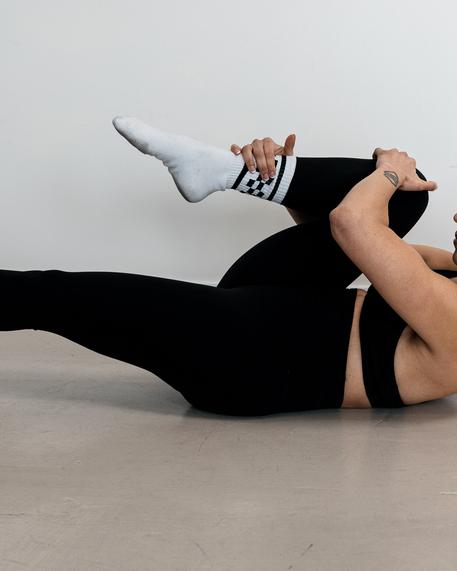 A member stretching on a mat with one leg extended