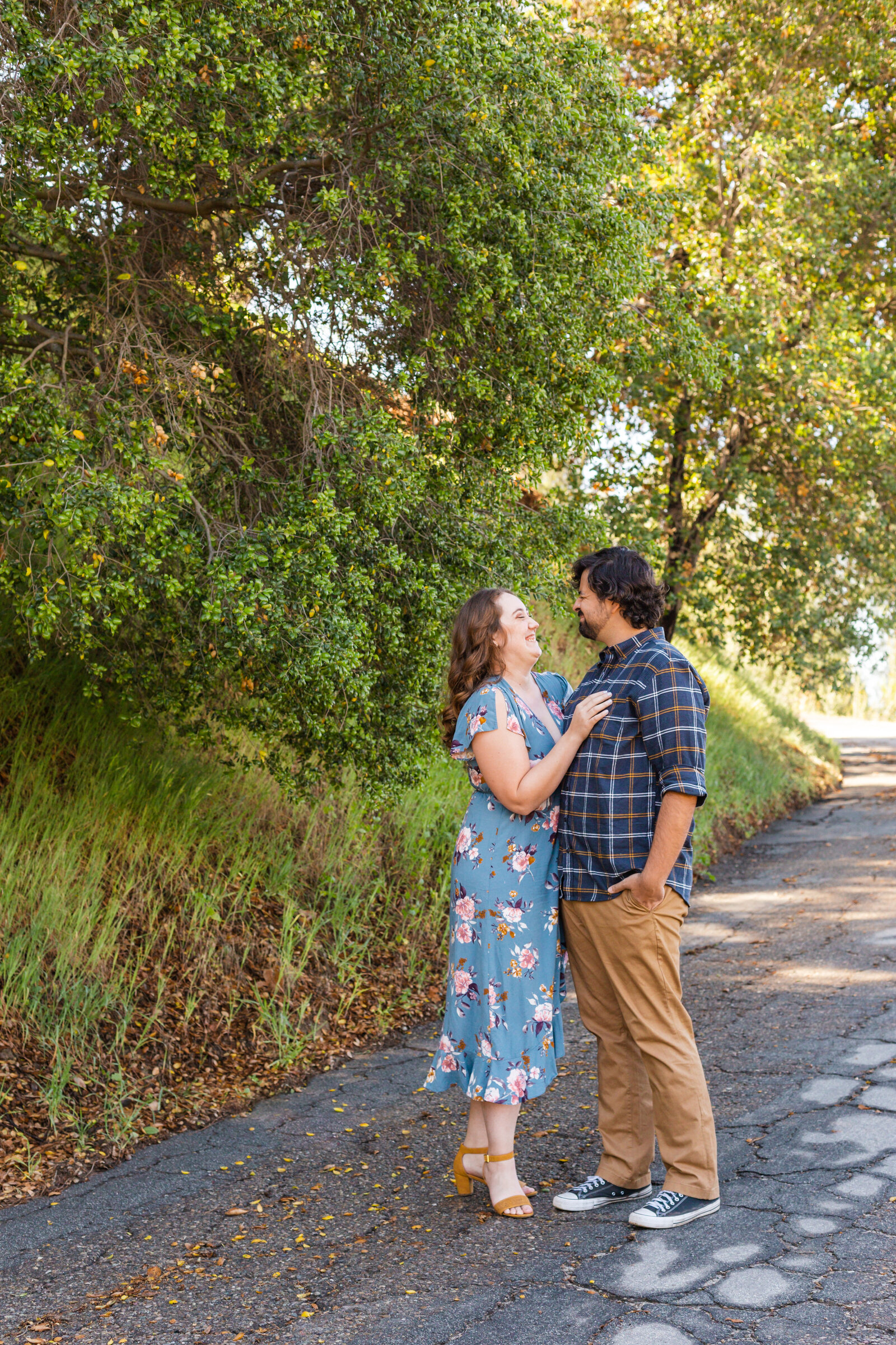 An engaged couple poses for photos in a garden in Los Angeles, Ca.