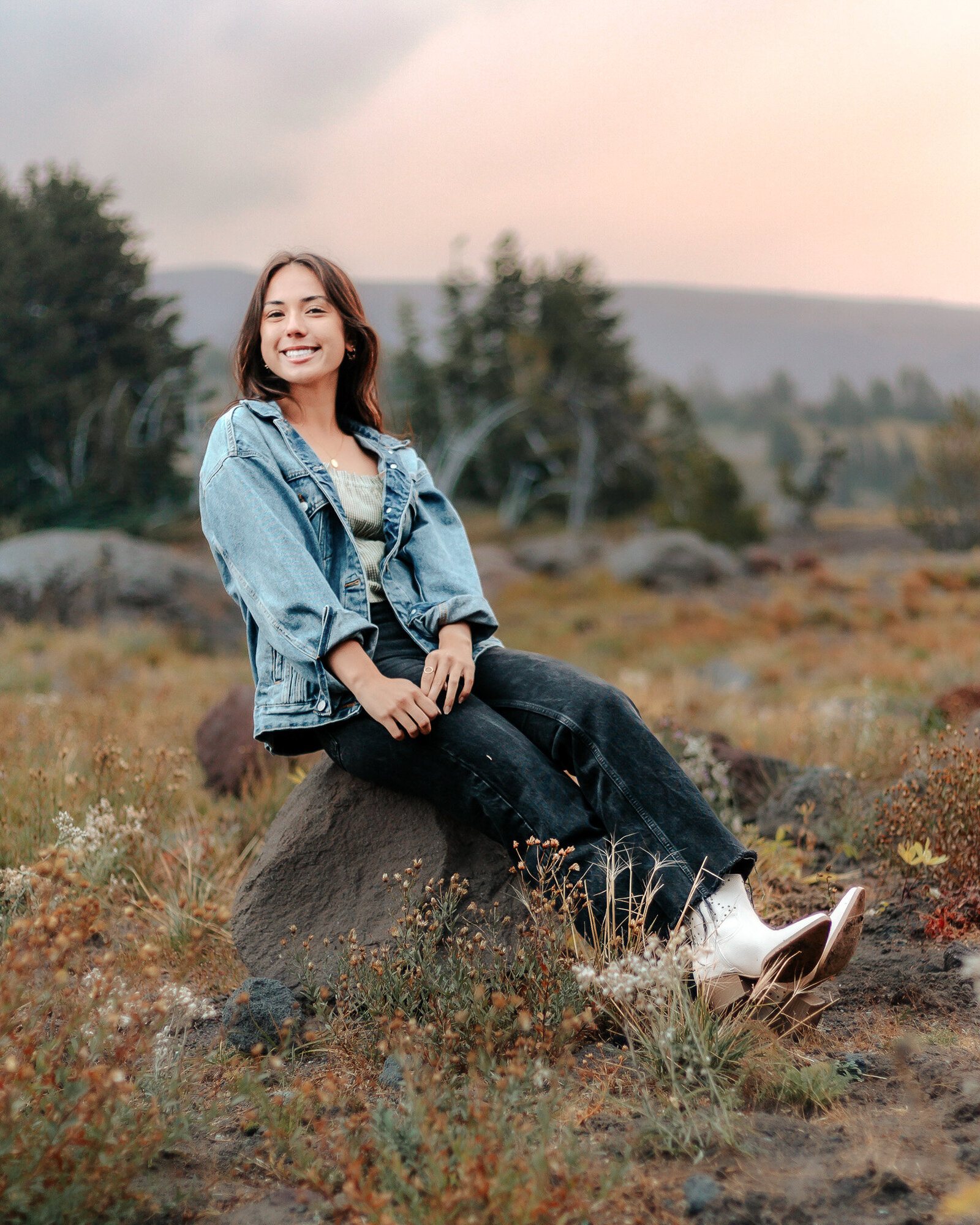 Girl sitting on a rock outside of timberline lodge