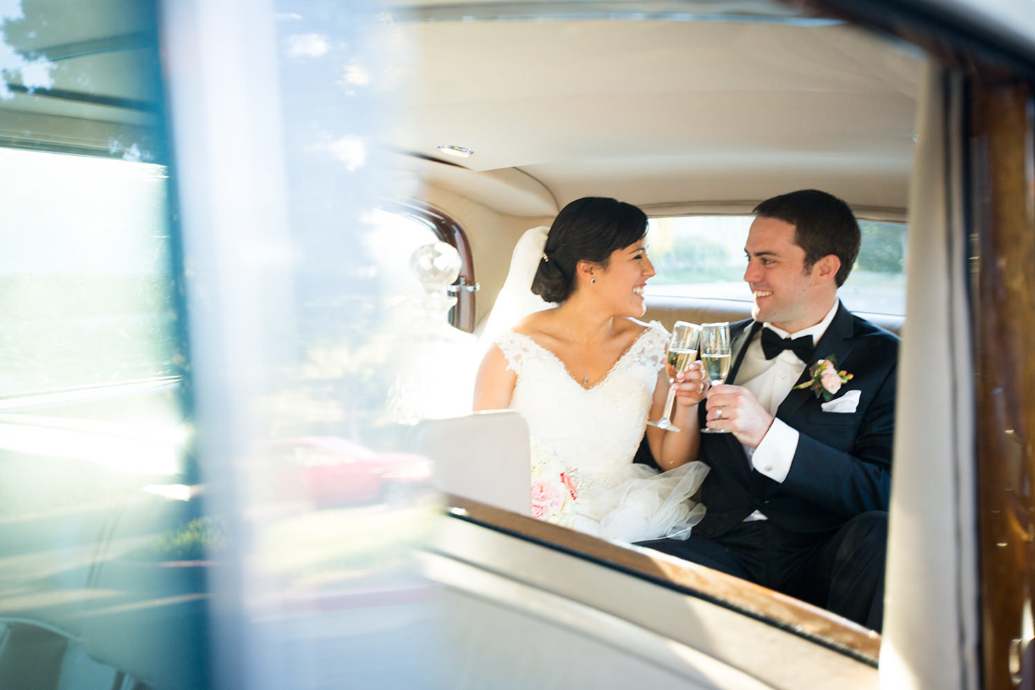 bride and groom at the crosby club beautiful light on bridge classic car