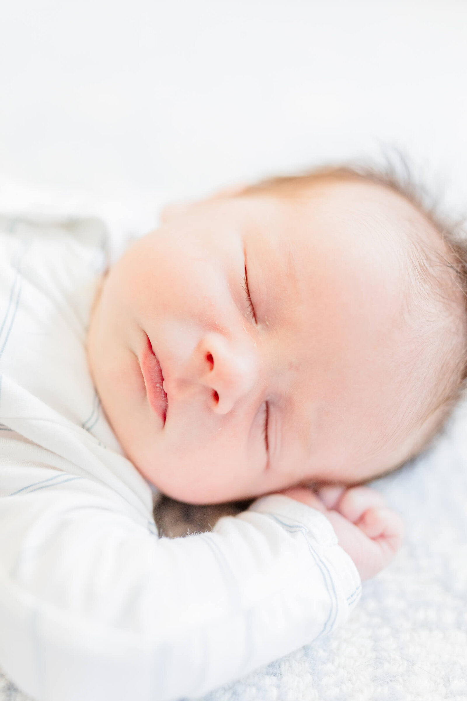 A closeup of the face of a sleeping newborn