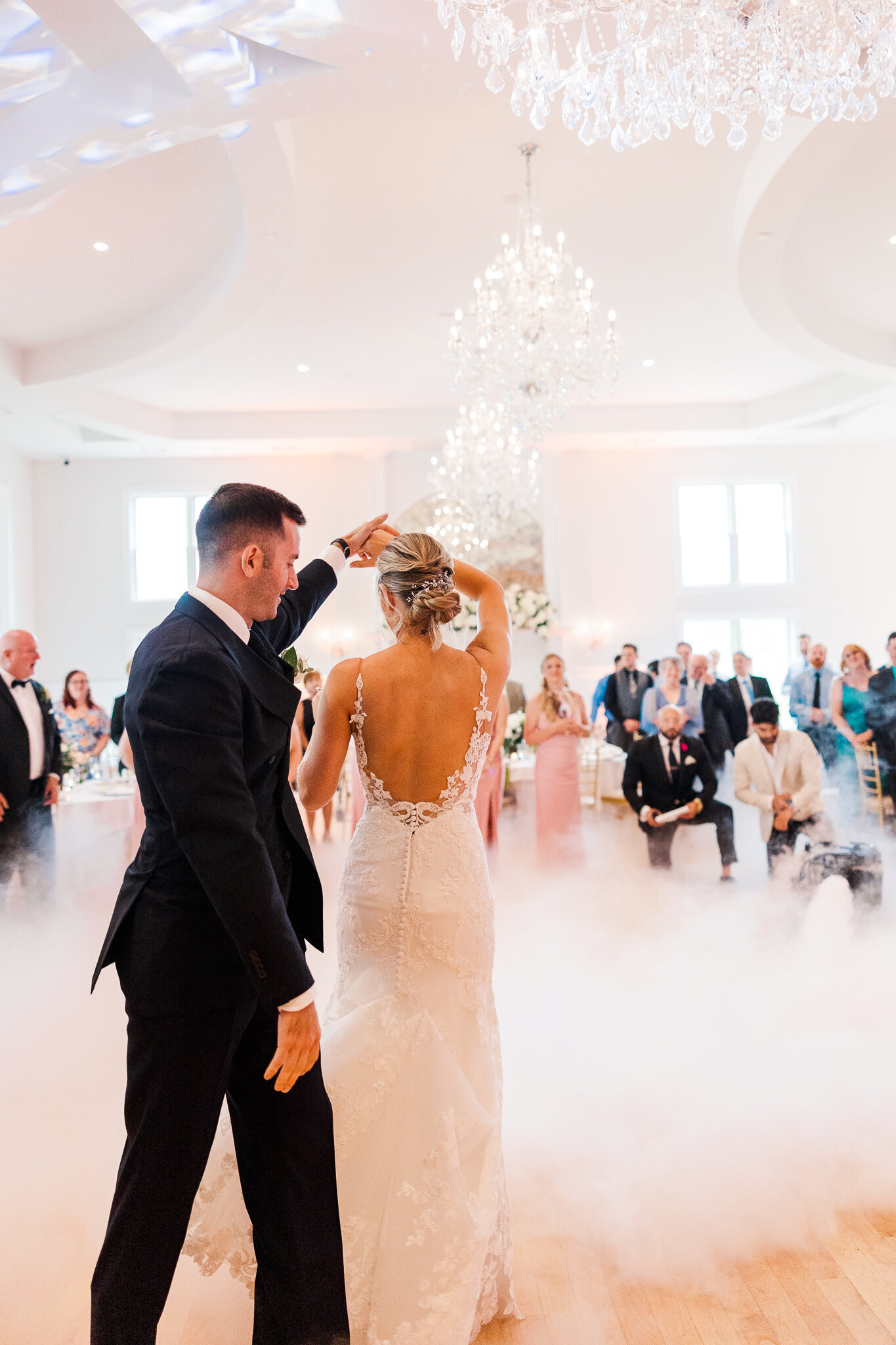 Groom spinning bride in elegant motion during their first dance at SkyView Golf Club