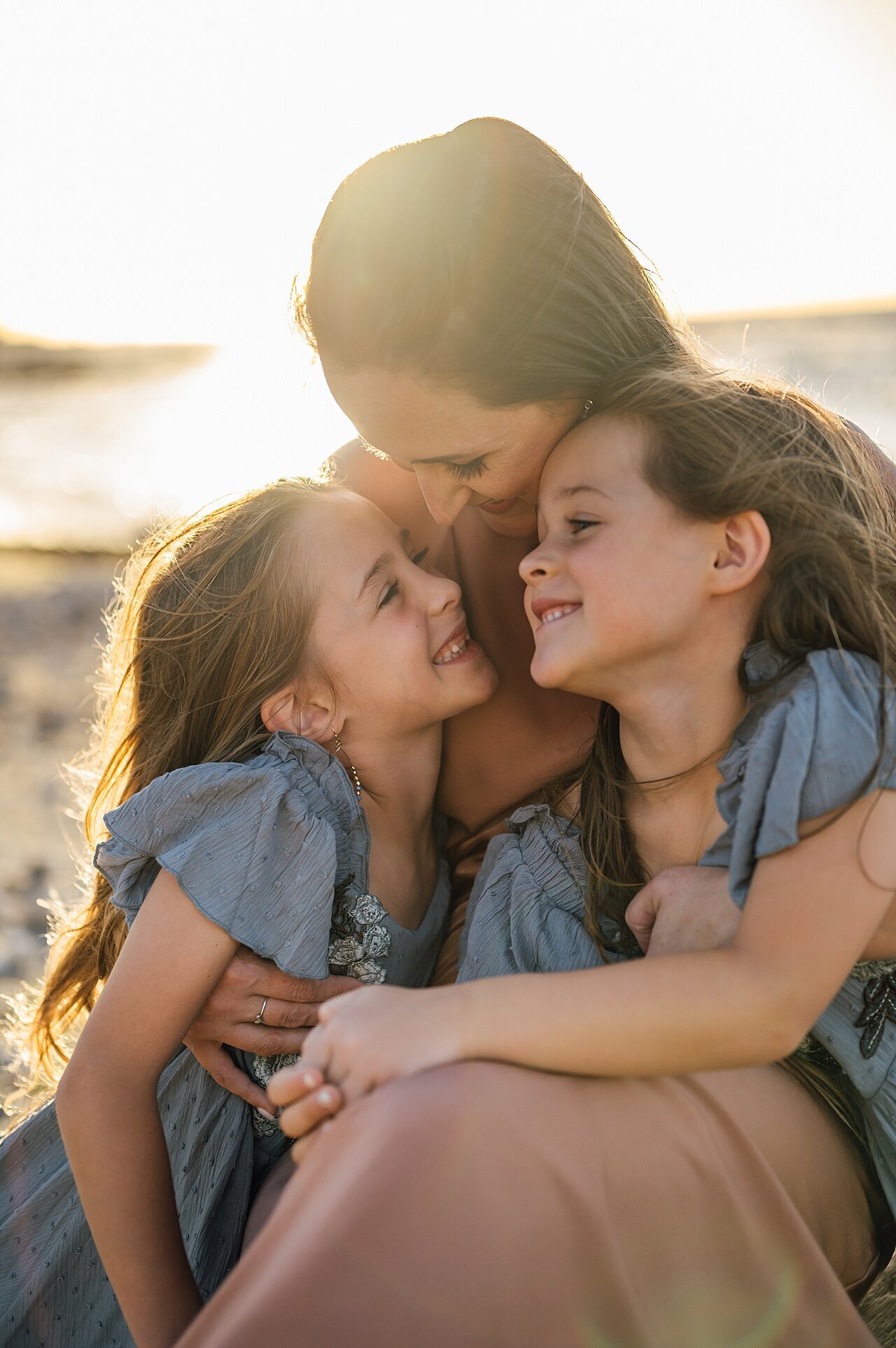 mom hugging her daughters